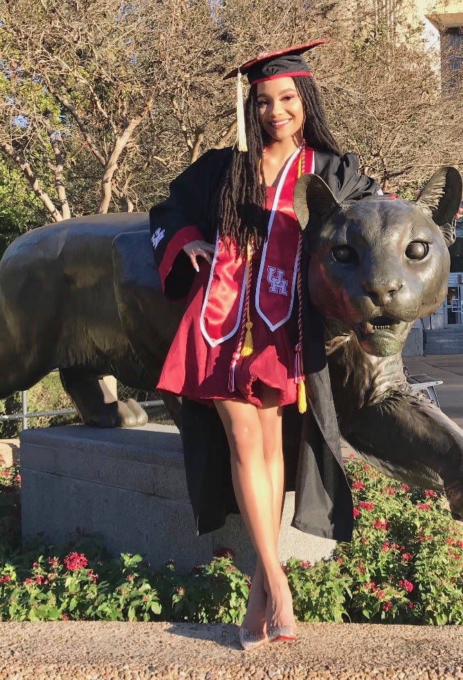 Salenah Cartier standing in front of bronze cougar statue