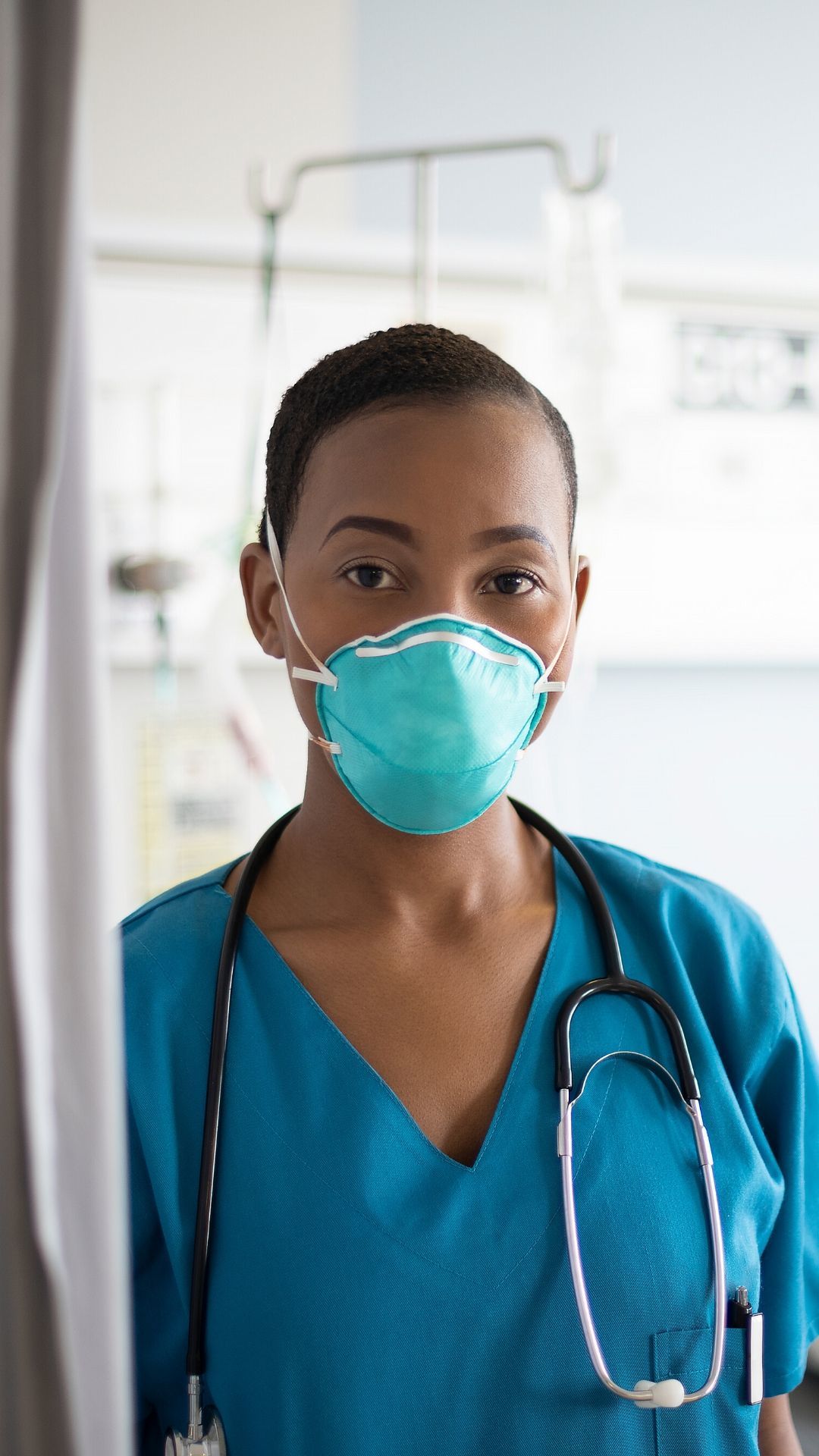 nurse in hospital room with face mask