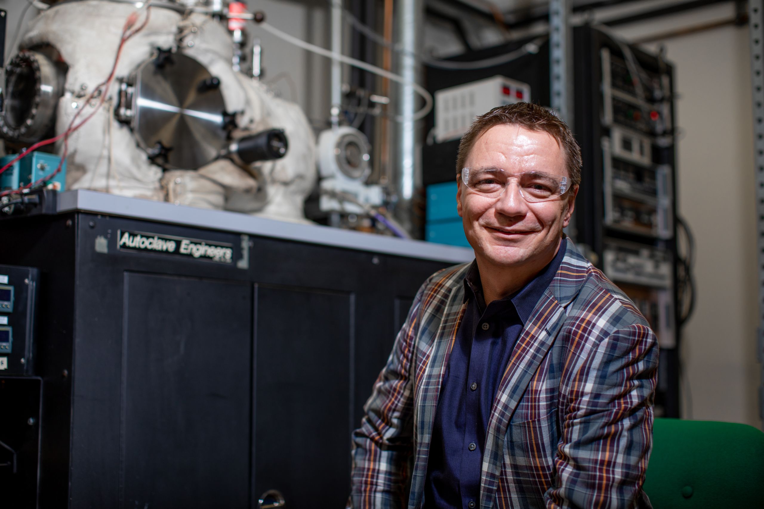 Grabow sitting in his research lab, smiling