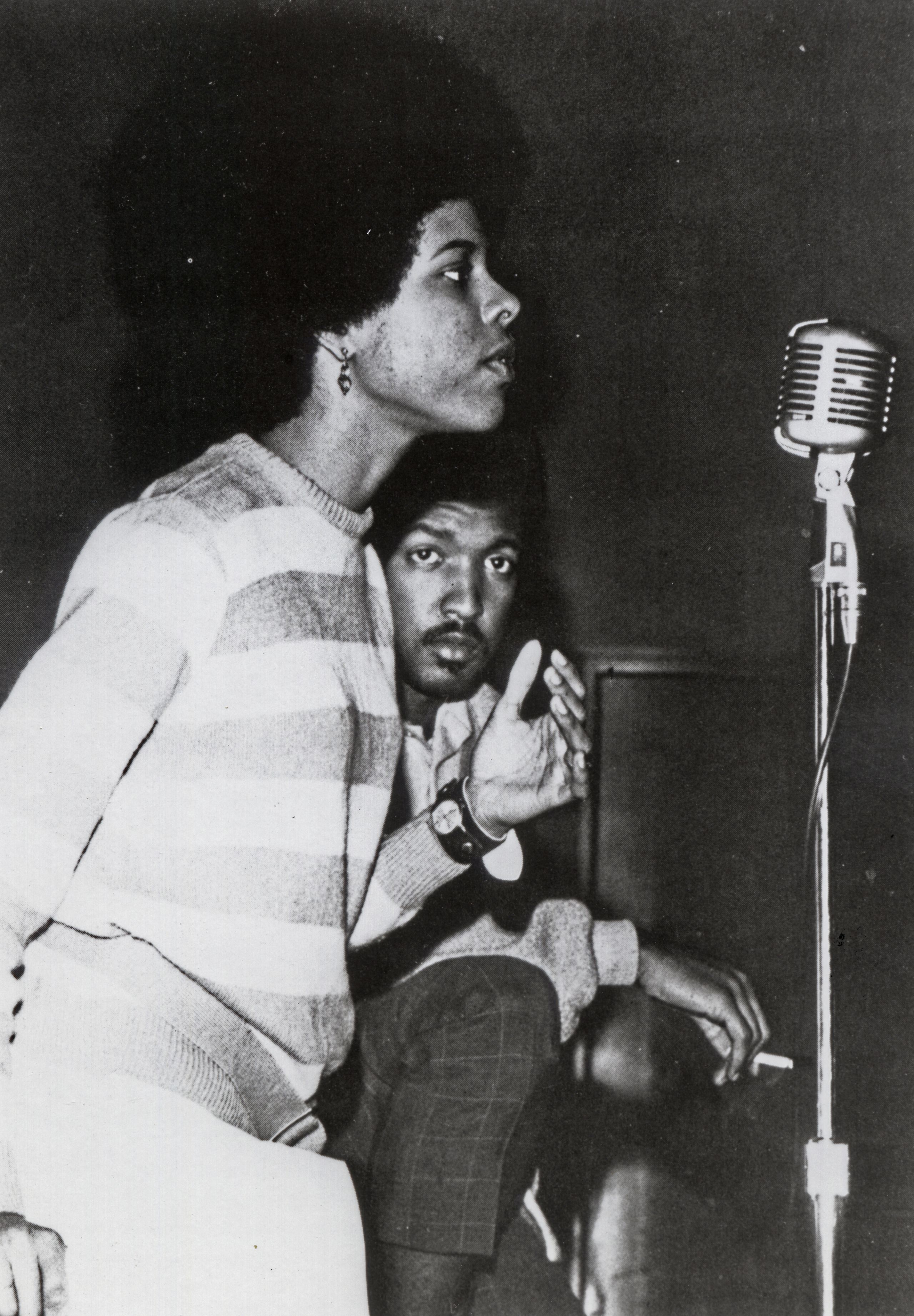 Lynn Eusan standing at a microphone