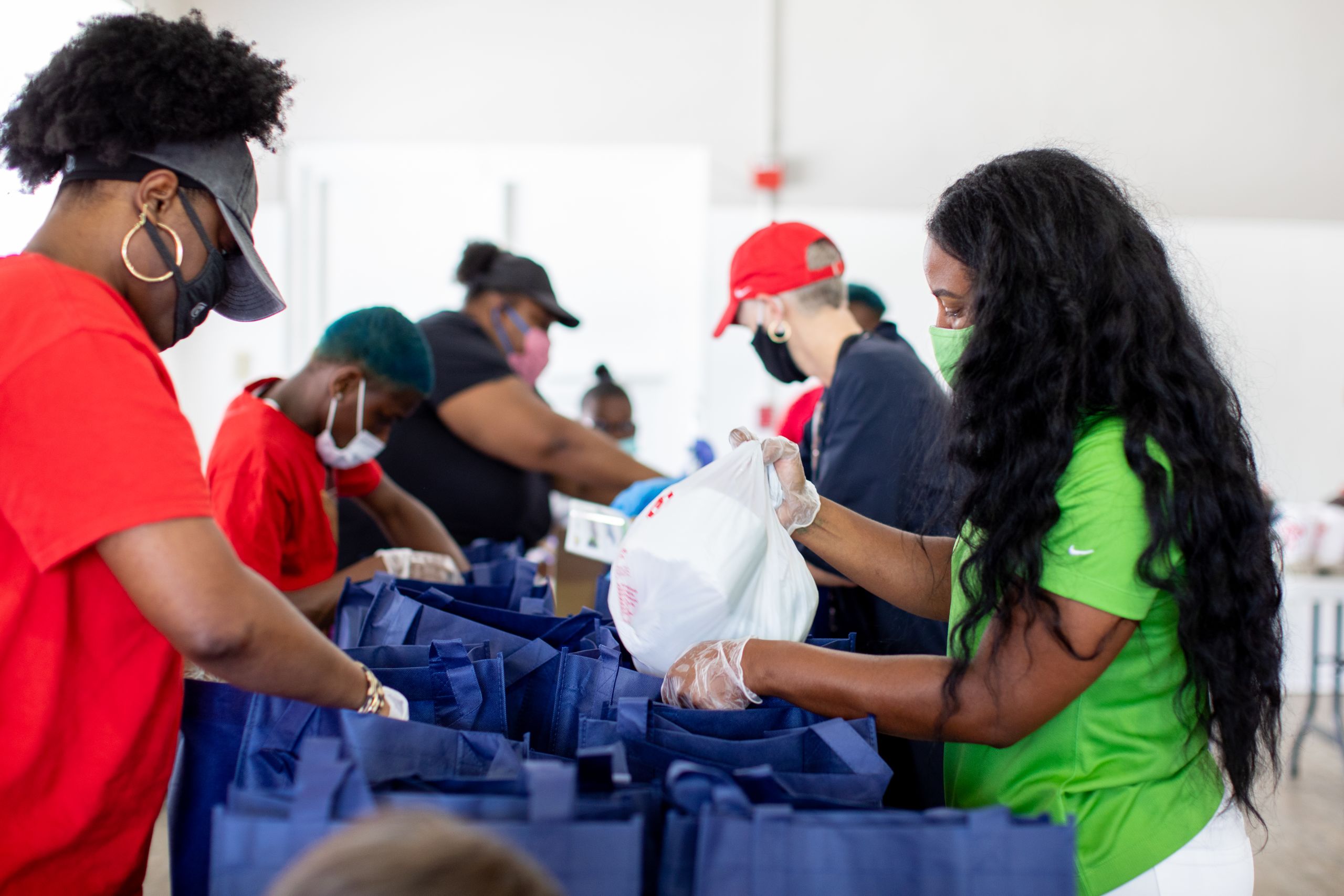 A volunteer packs a bag of toiletries.