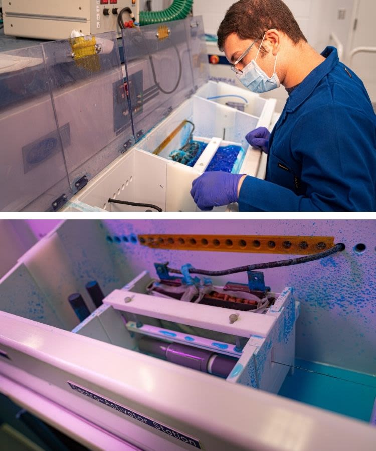Man in lab looking at wire undergoing testing in machine