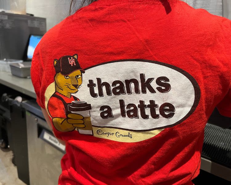 student worker wearing a T-shirt that says "thanks a latte"