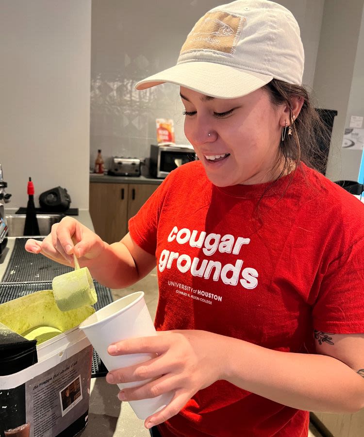 Student worker making a drink