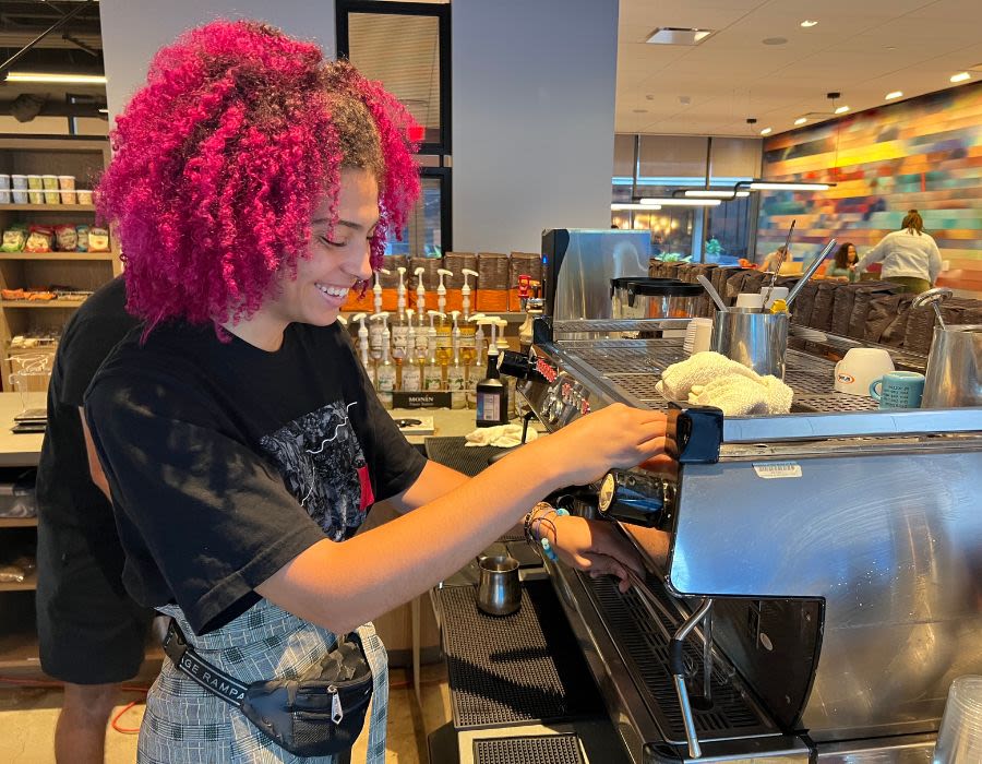 student worker making coffee