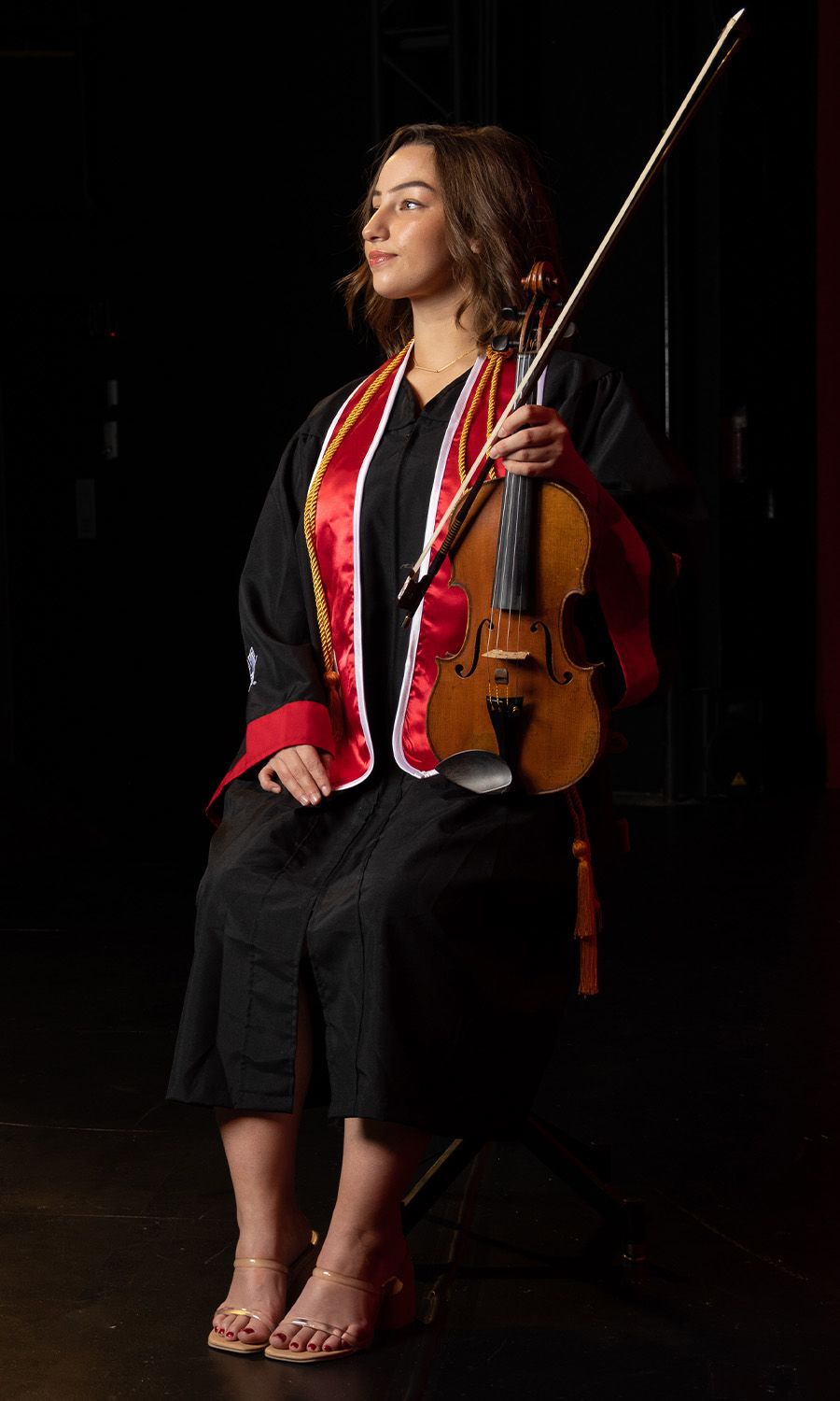 Miranda posing in her gown with her violin