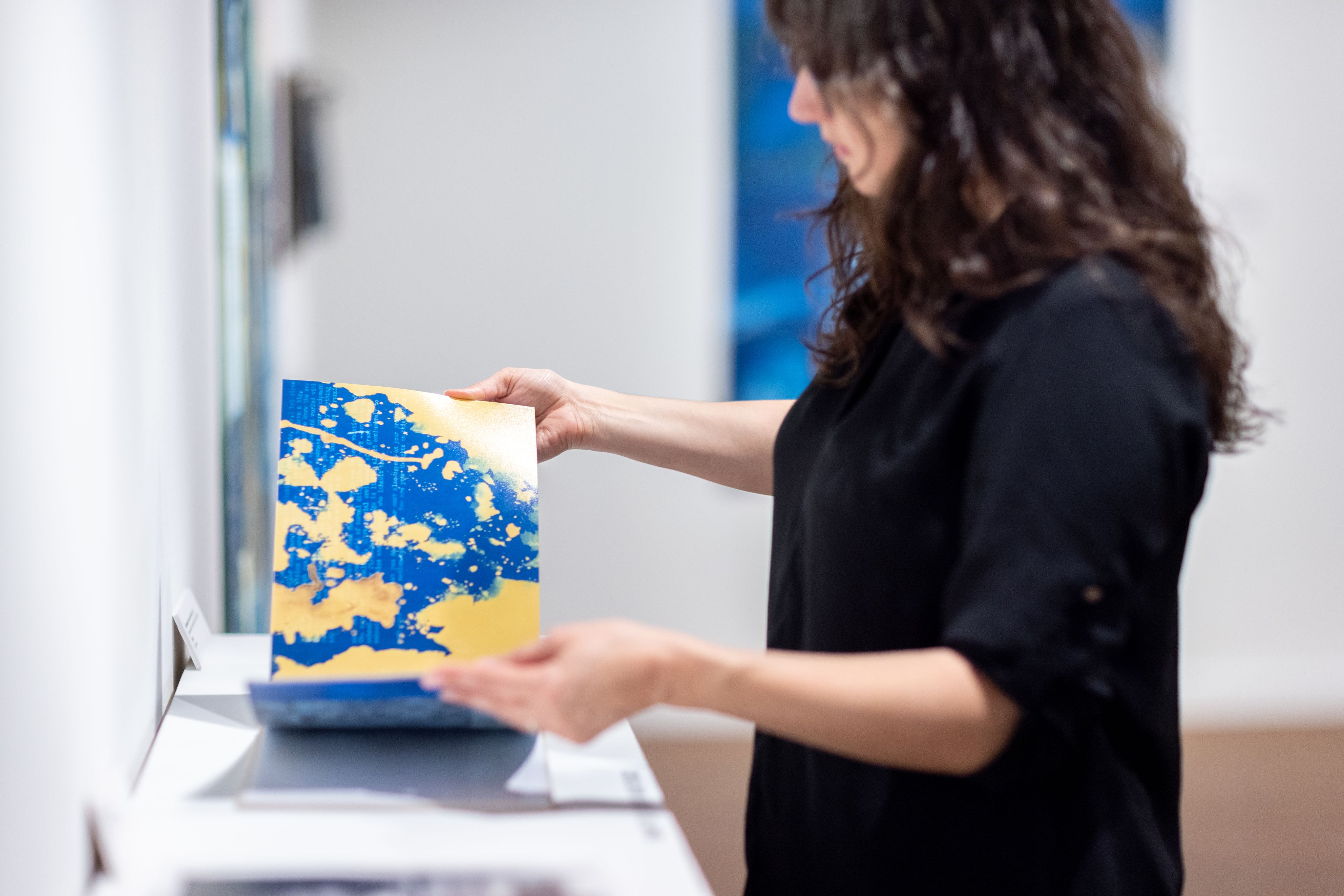 Anderson-Staley flips through pages of artwork