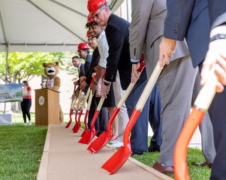 shovels in sand at groundbreaking