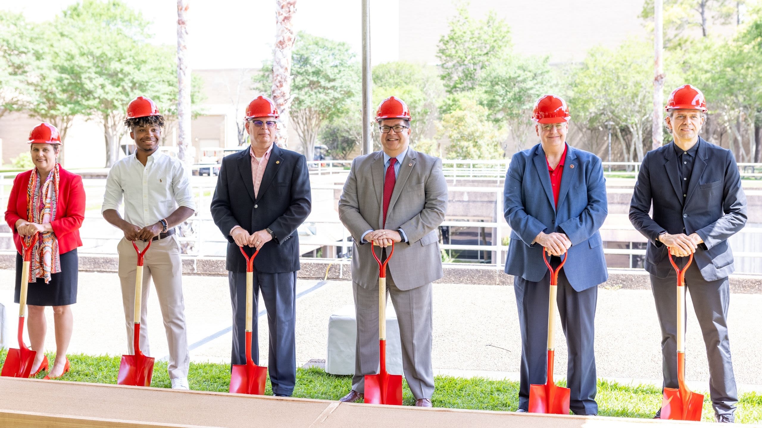 UH leaders posing with shovels