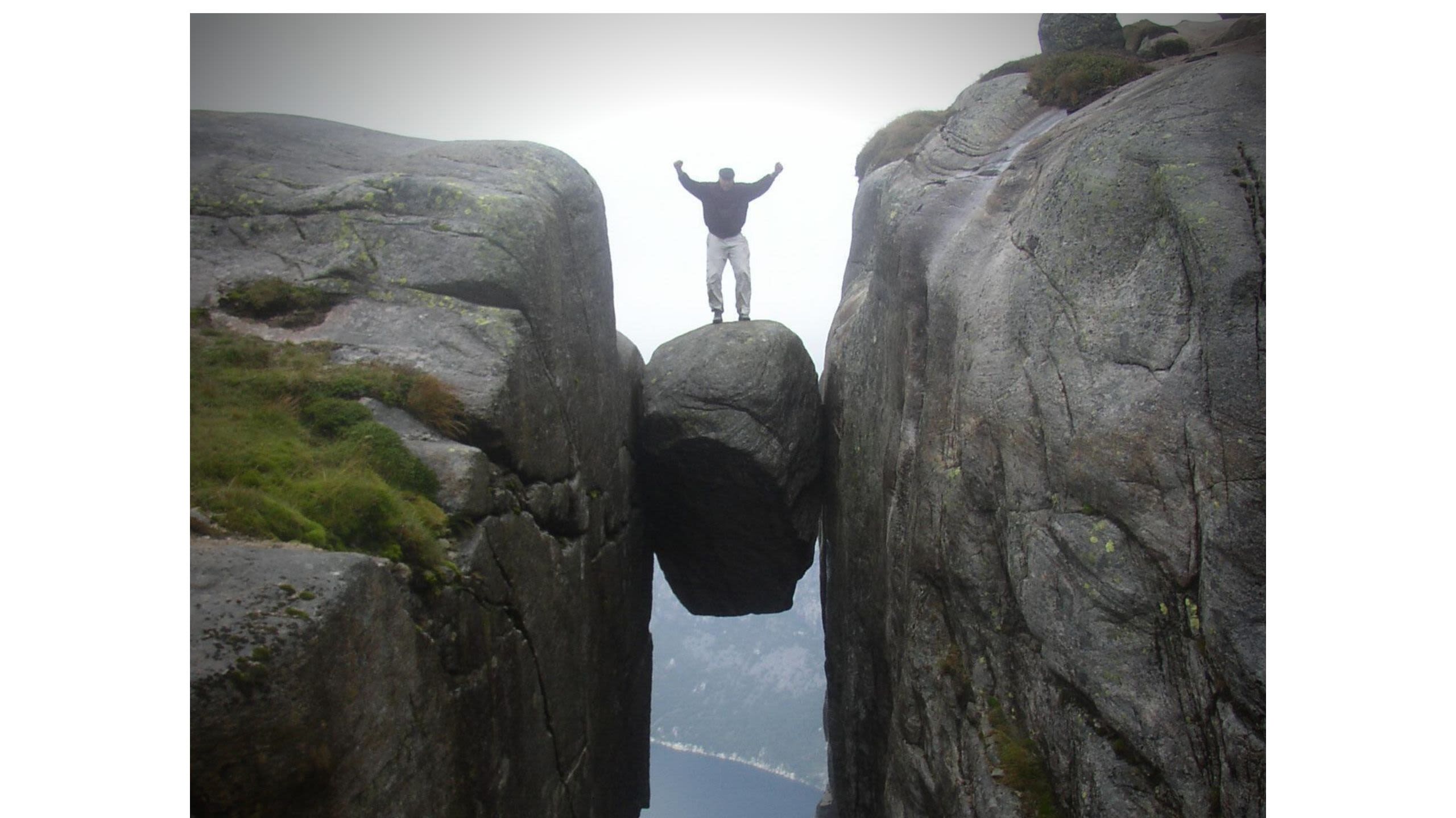 Professor Thomsen posing on Kjeragbolten, a boulder on the mountain Kjerag in Norway in 2004.