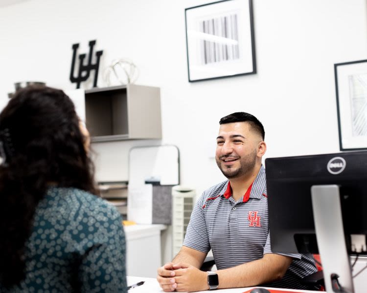 Cristian Garcia works with a new employee.