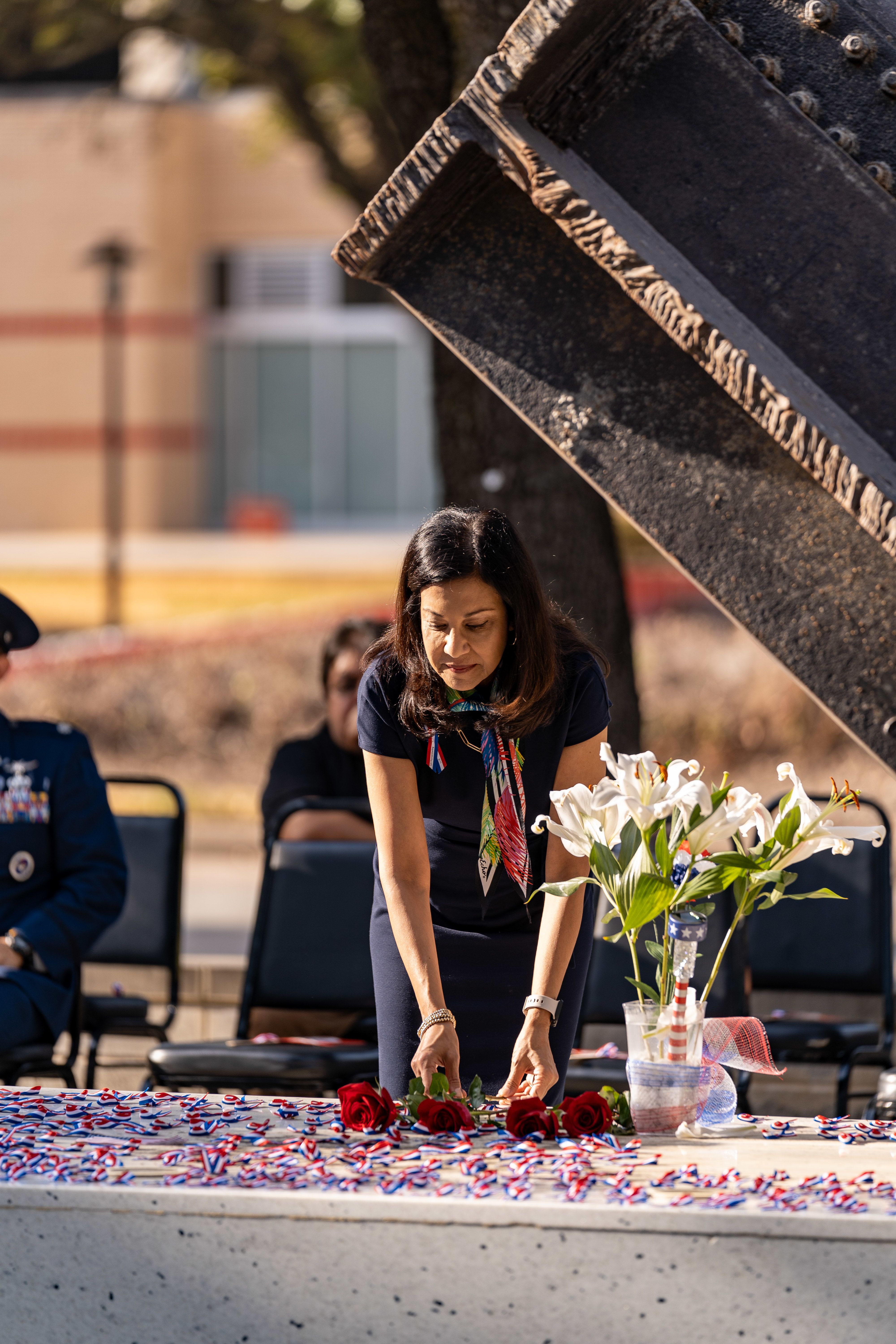 Participant lays flowers beneath a steal beam from the World Trade Center.