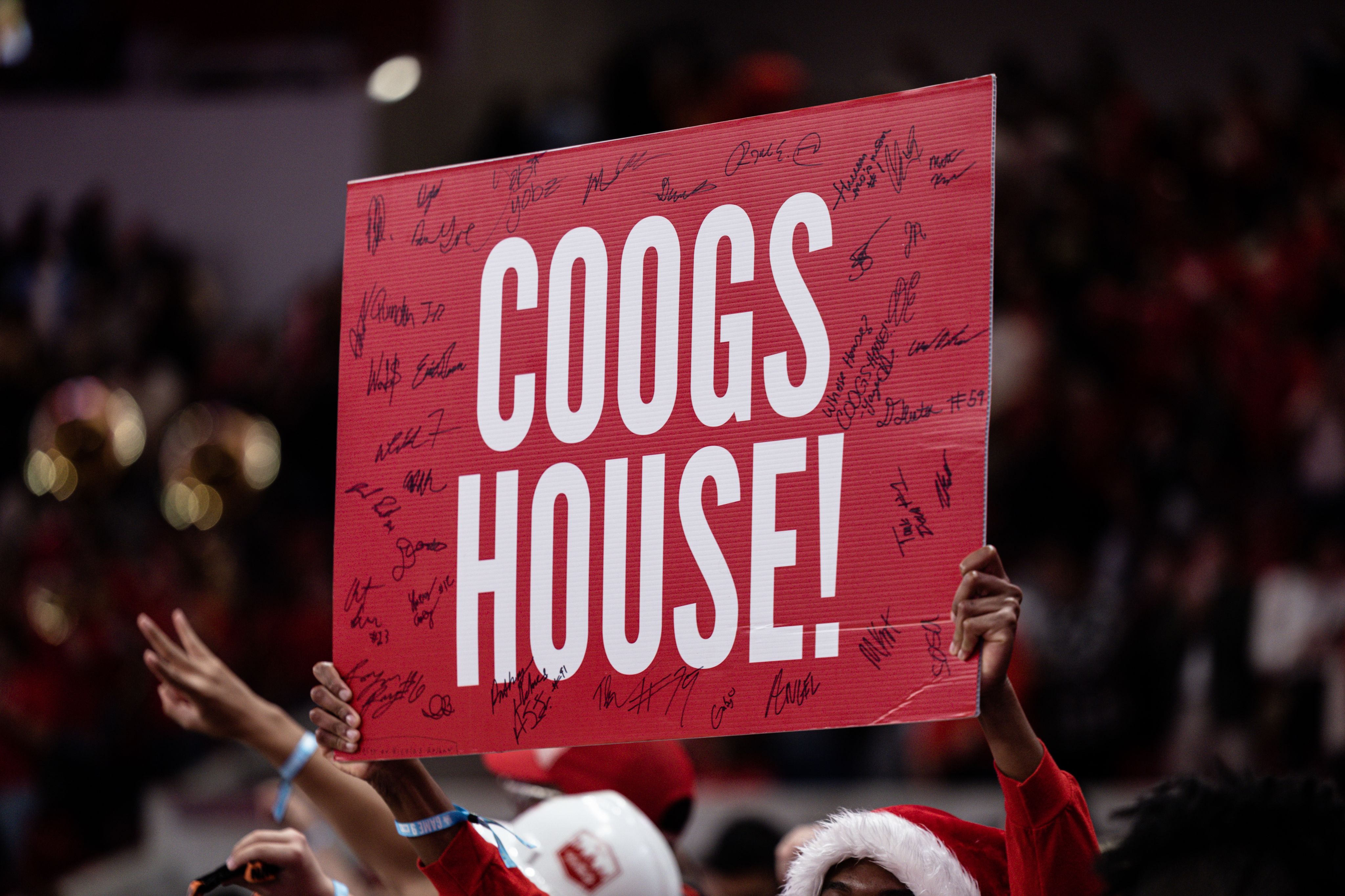 Sign that reads "Coogs House!" and is covered in signatures.