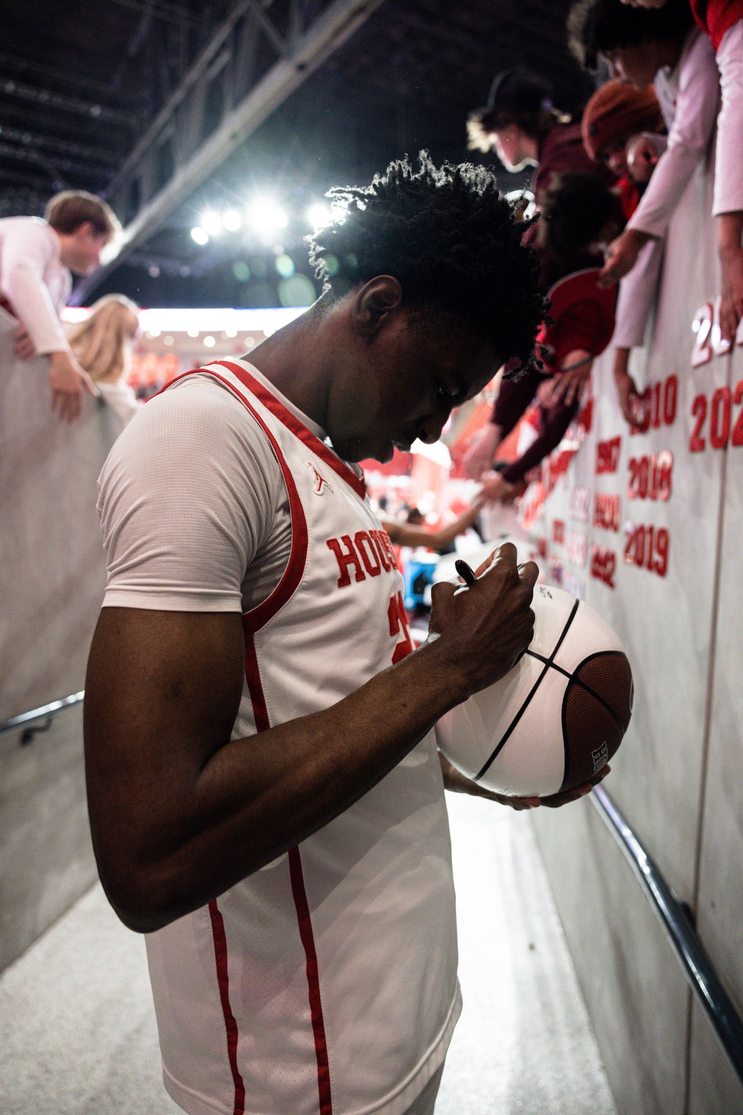 Terrance Arceneaux signs a fan's basketball.