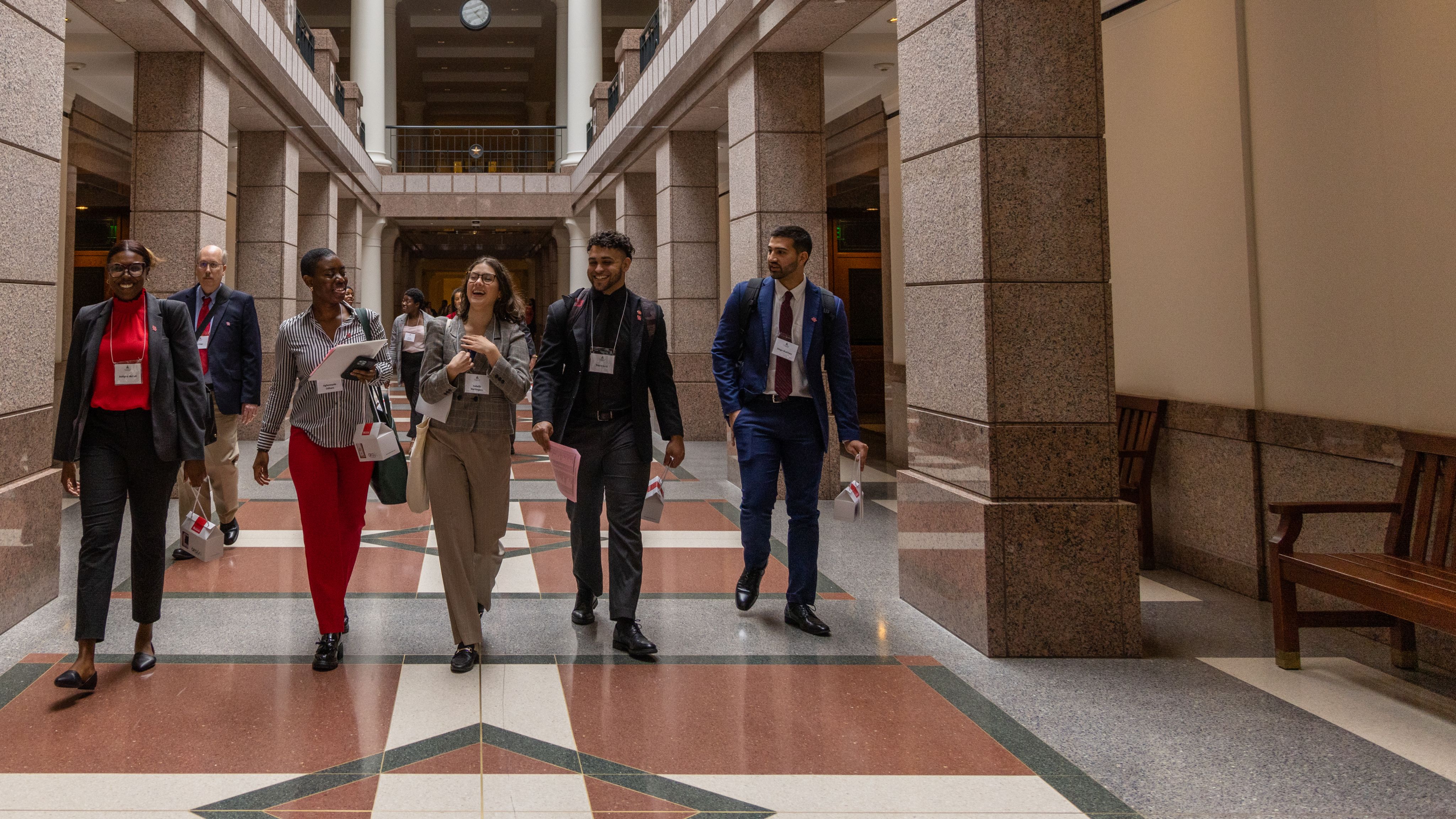 A Group of students walking down a long hallway.