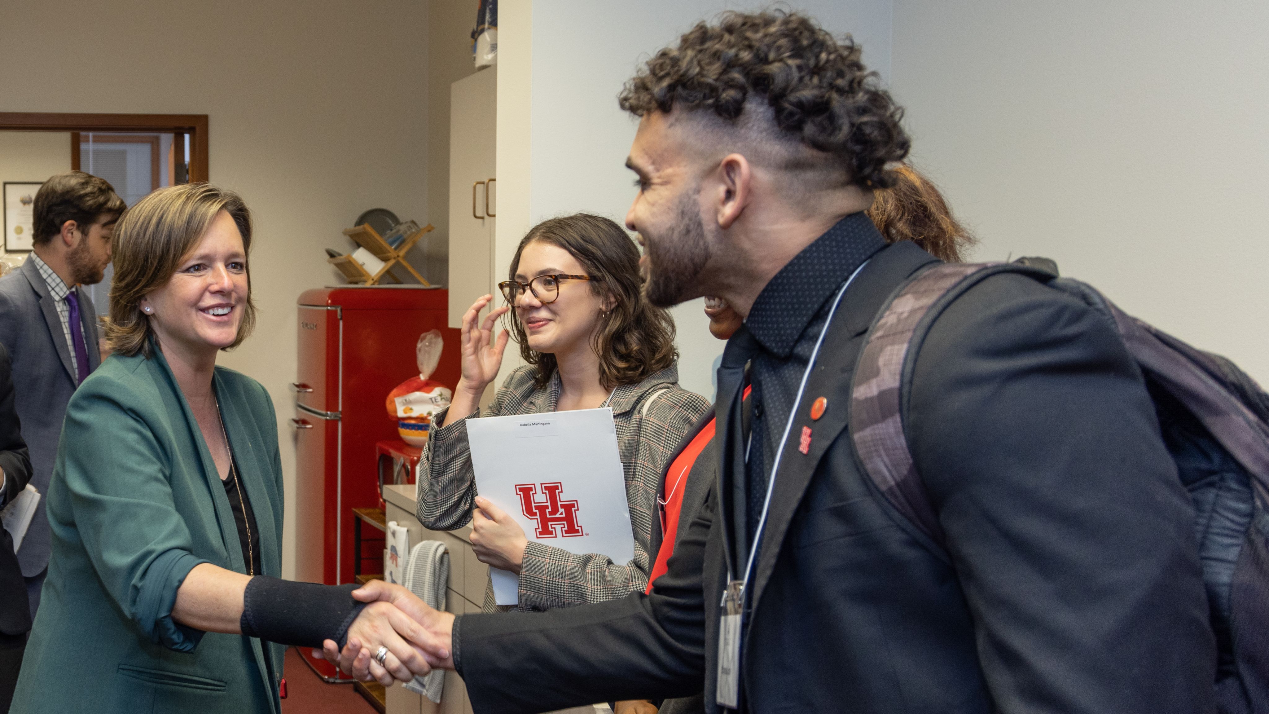 Texas Senator shaking hands with a student.