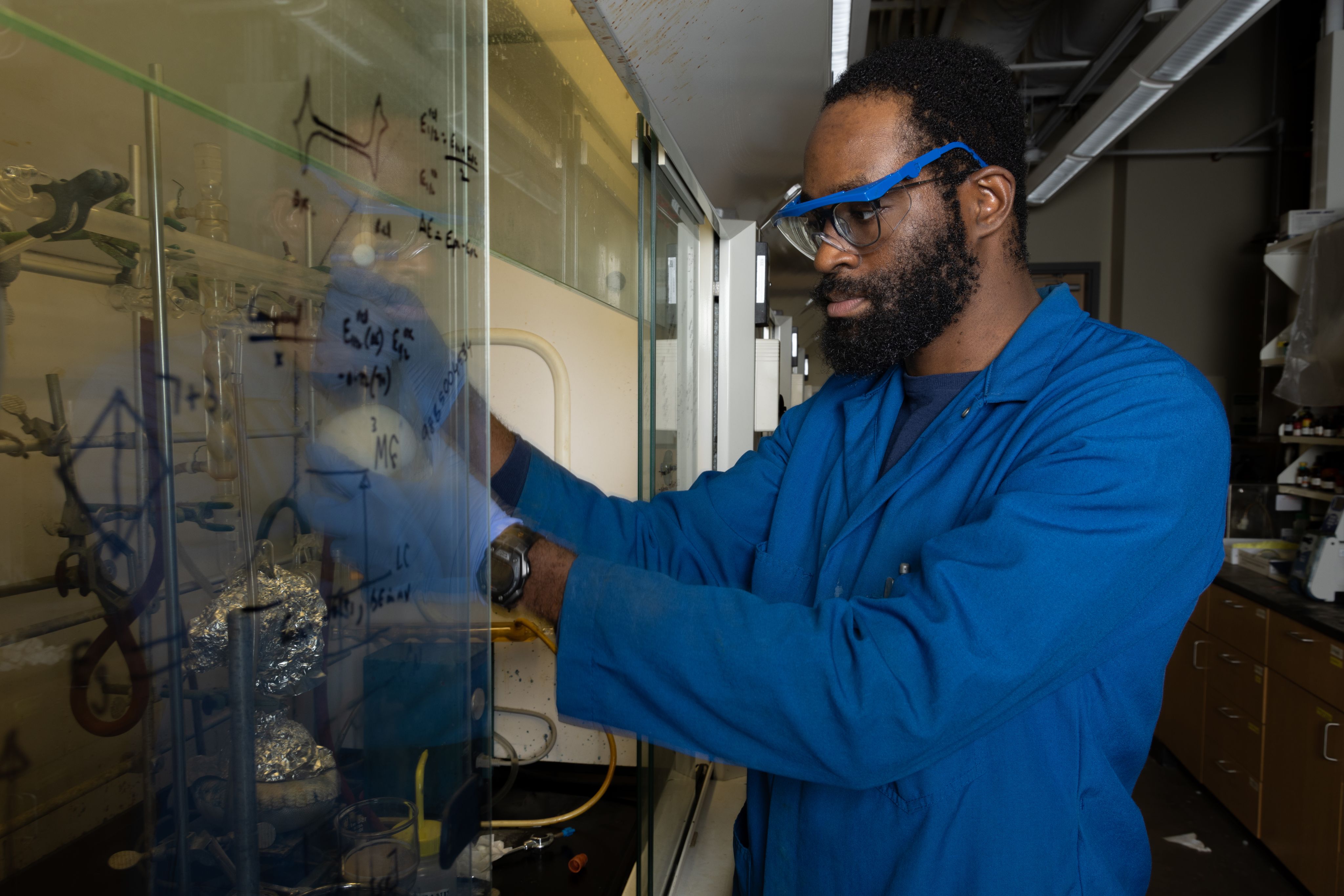 African American man in blue outfit in laboratory