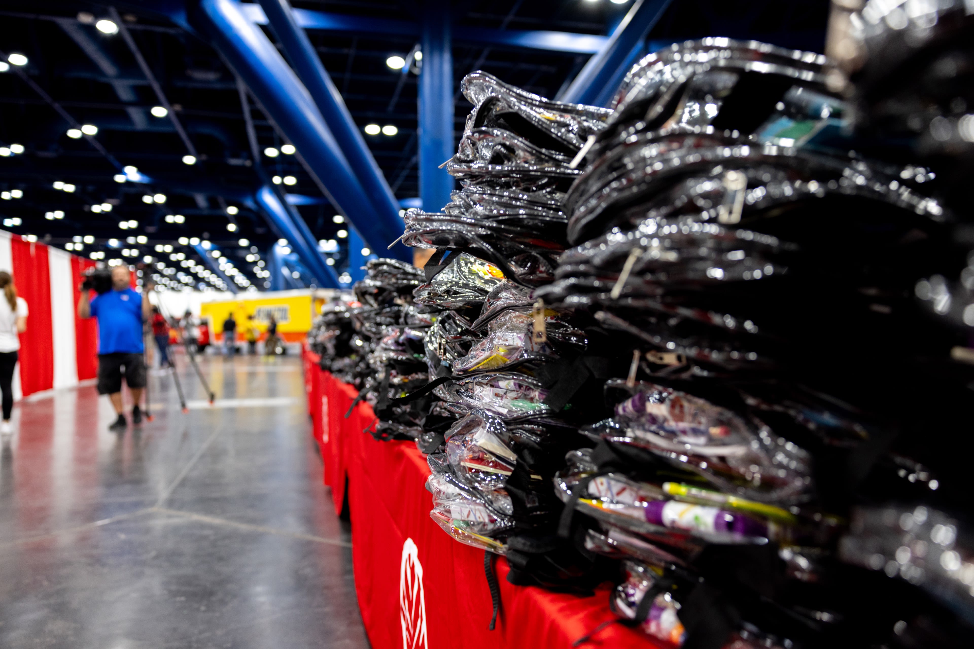 a very large pile of backpacks