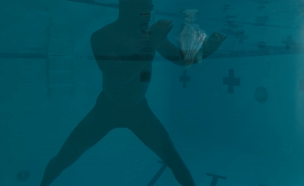 A scebe from unMaskulinity with a man diving underwater.
