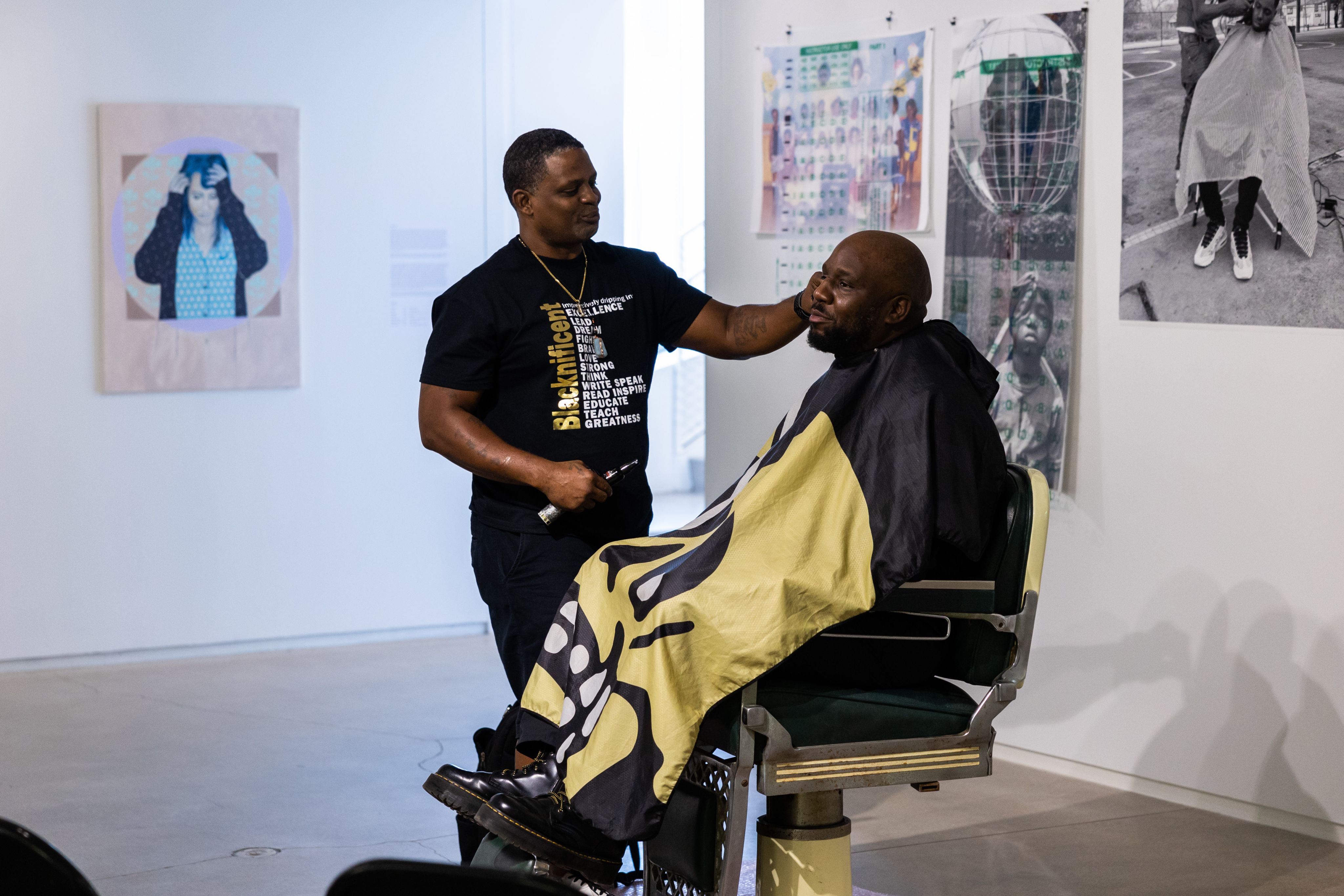 Brian Ellison get a haircut in a barbers chair at his senior thesis display at blaffer art museum