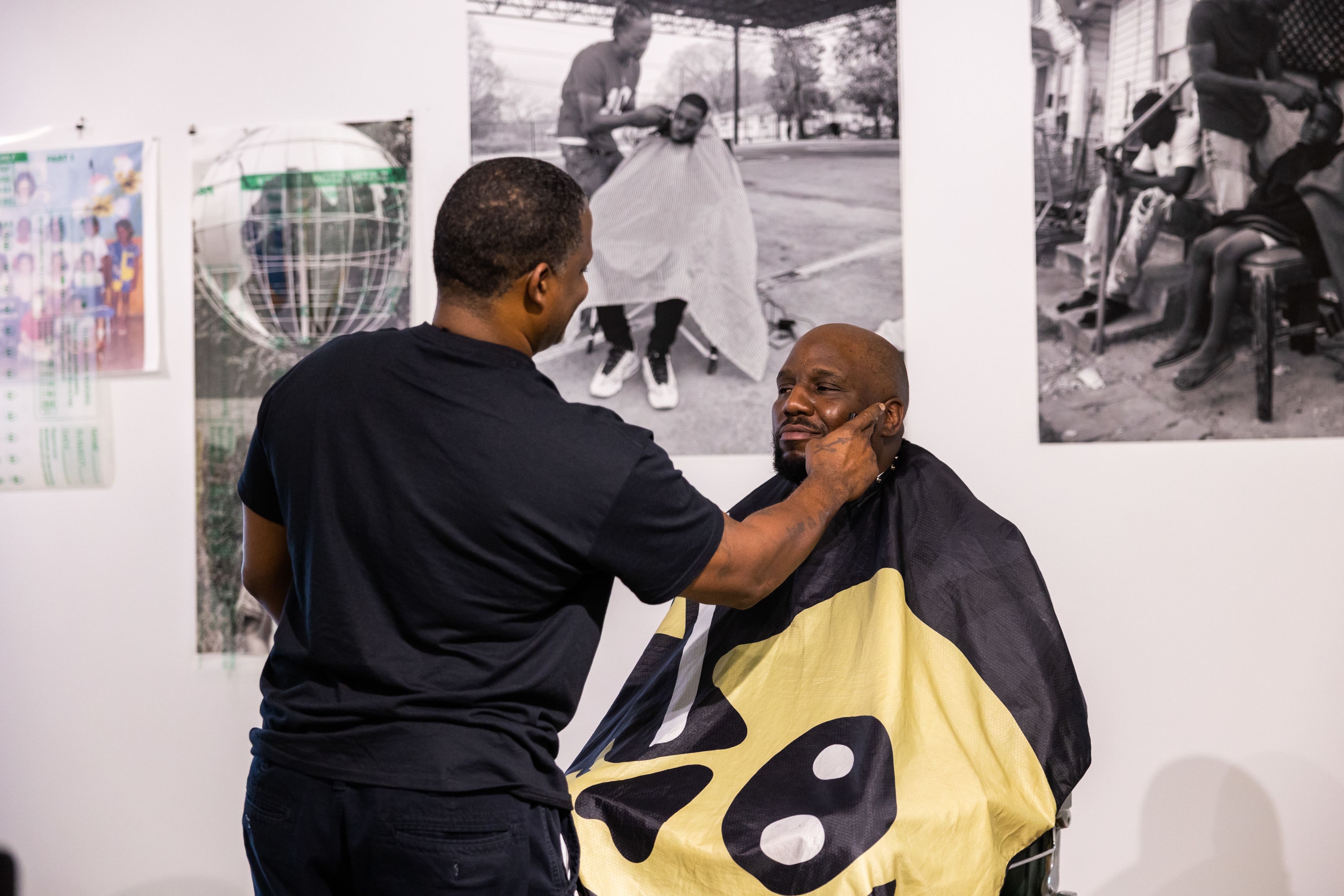 Brian Ellison gets a haircut in a barber chair at his senior thesis at blaffer art museum