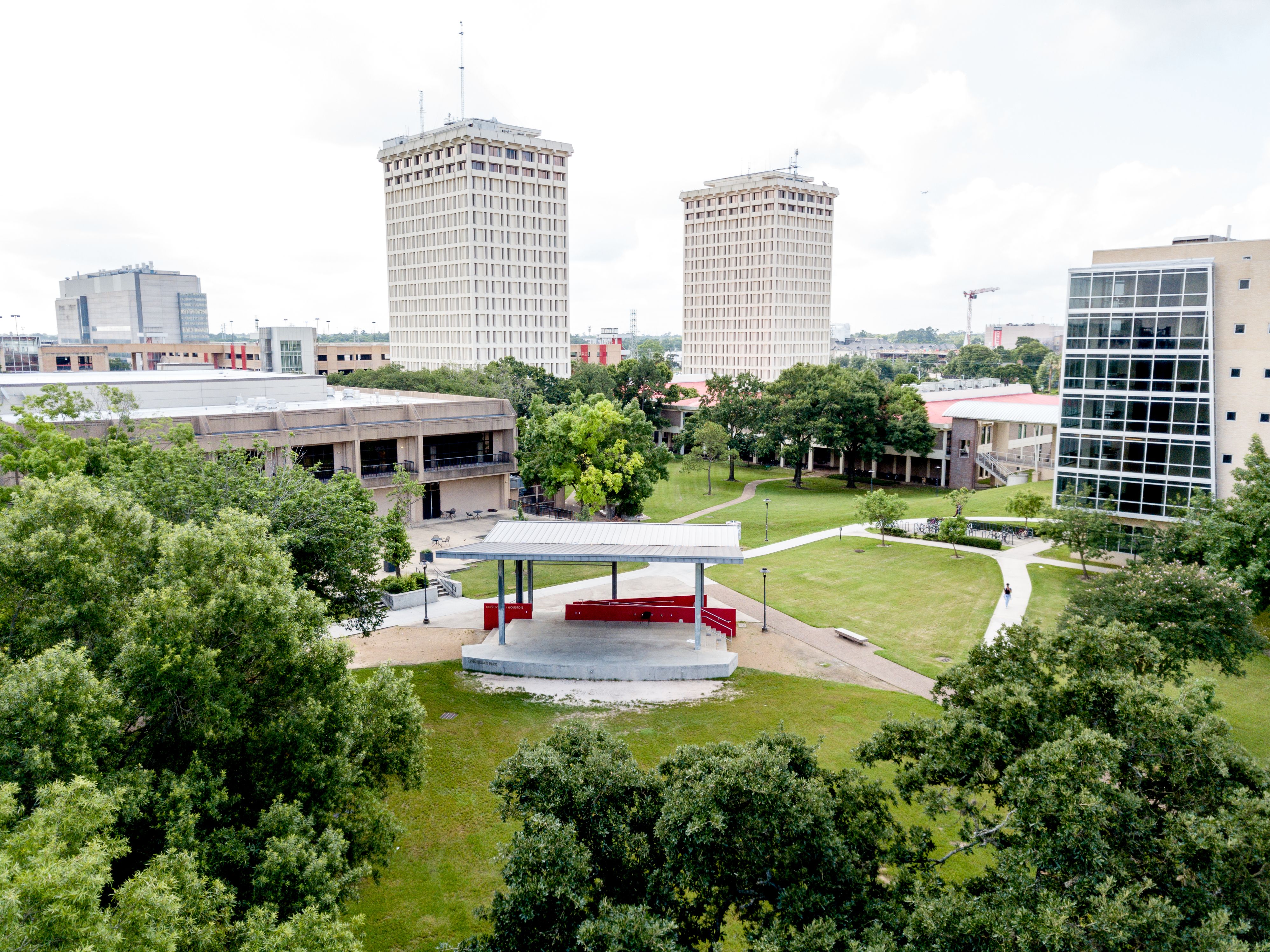 Aerial view of Lynn Eusan Park. A covered, outdoor stage is the centerpiece of the park, with green space and trees filling other areas.