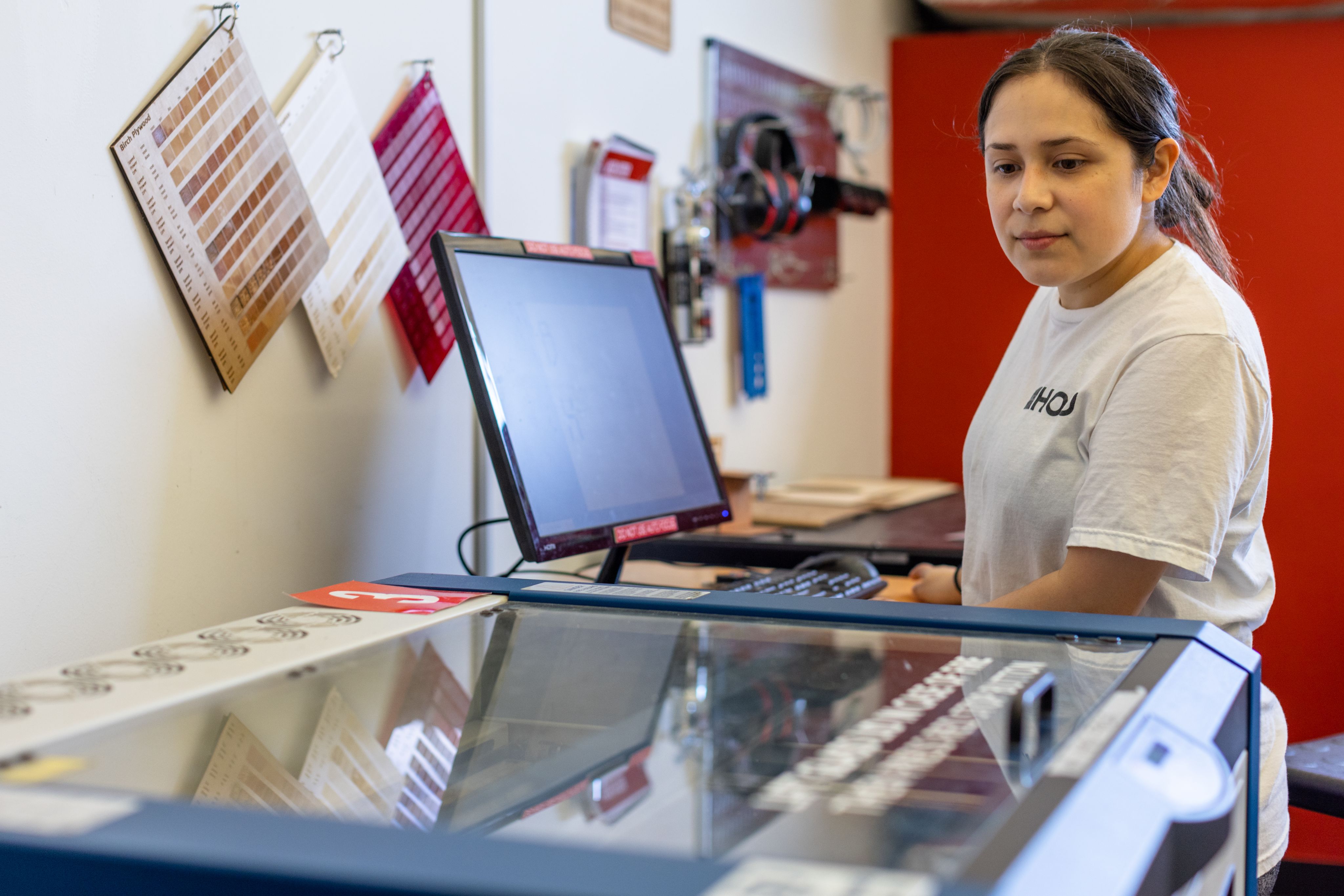 Art Student Bereniz Velazquez at the laser cutter machine.