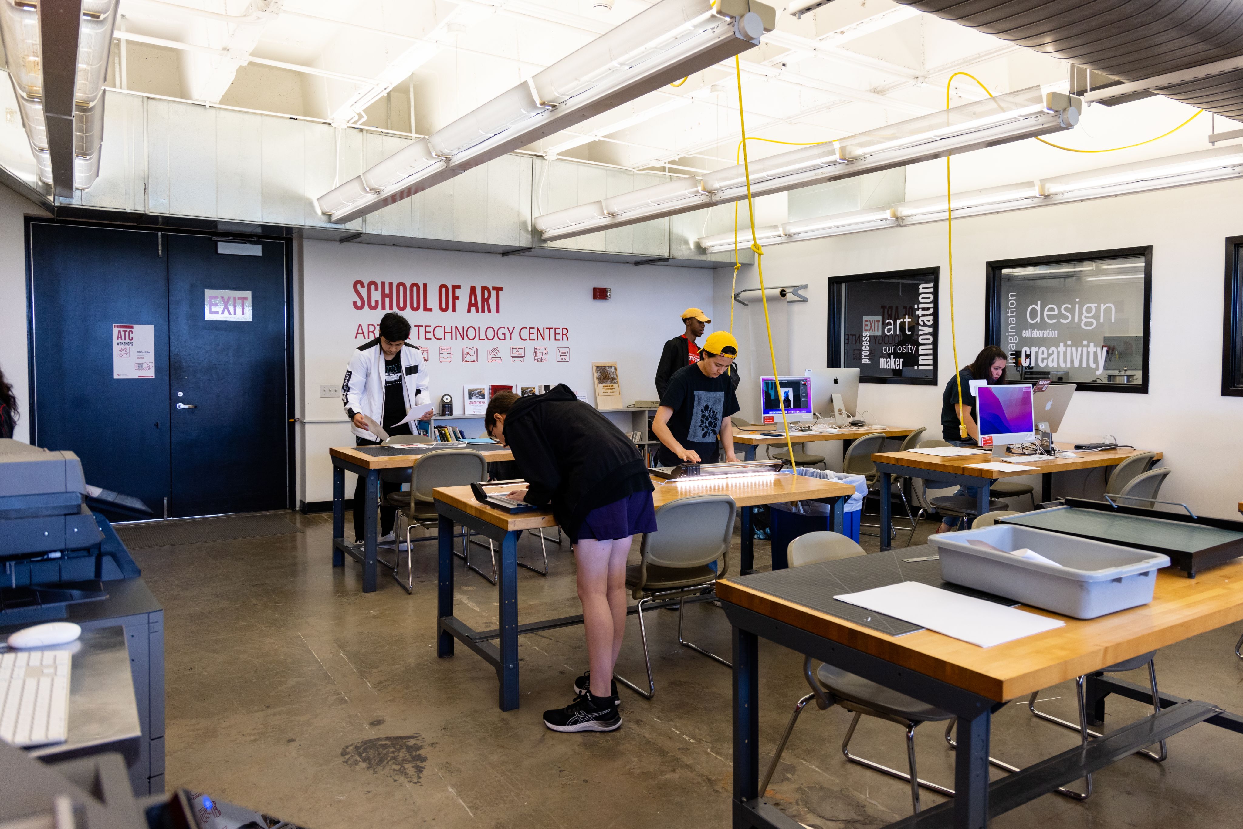 Photo of students working at stations at the Art & Technology Center