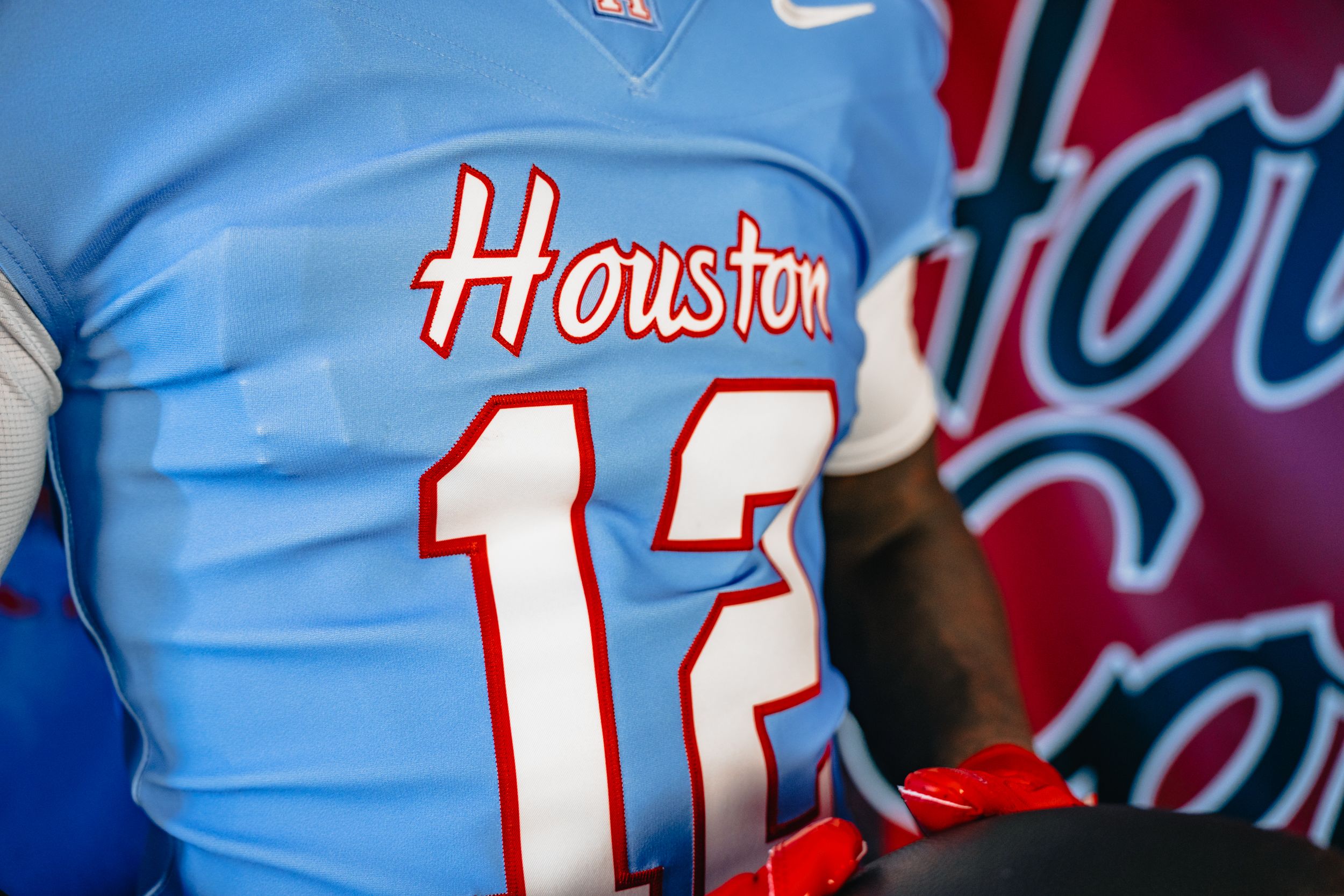 Close up of the Houston Blue jersey with Houston and the number 12 in white and outlined in red