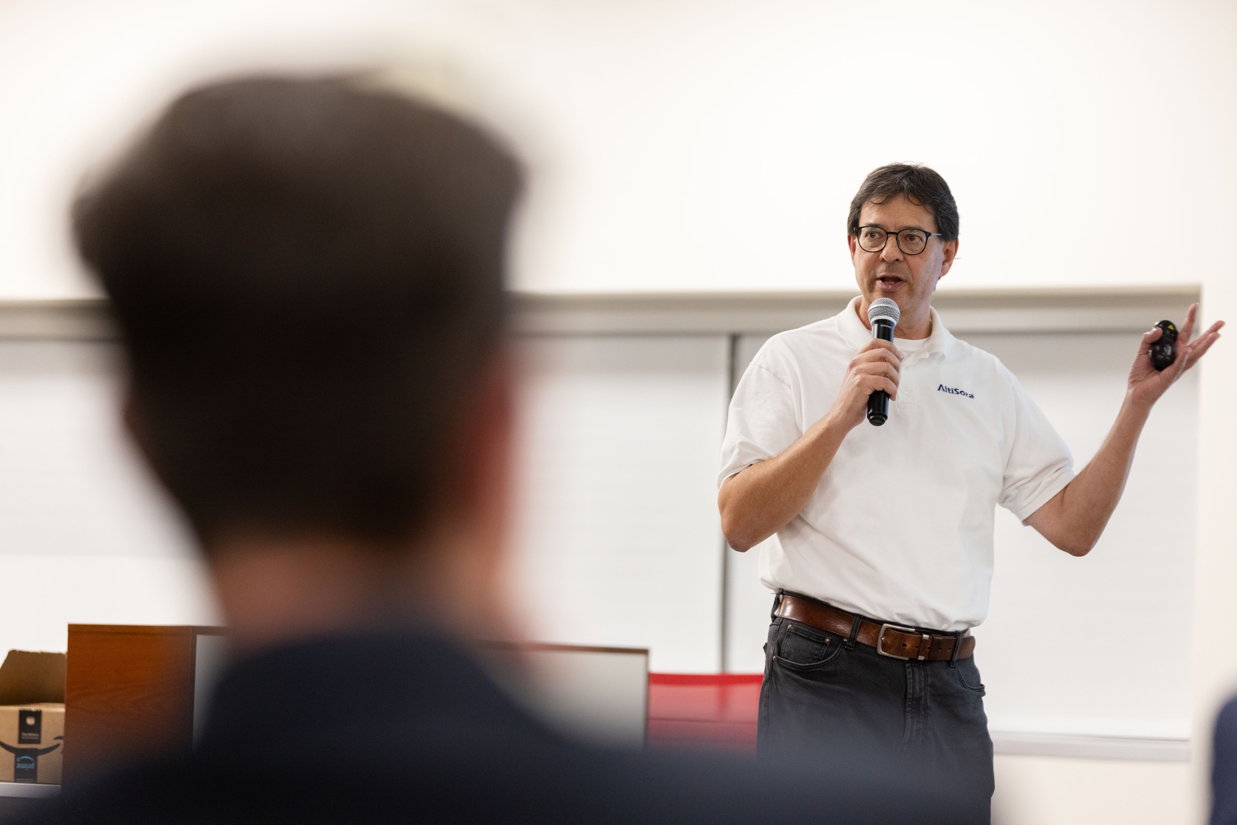 Man doing a presentation in front of a crowd of potential partners during pitch day
