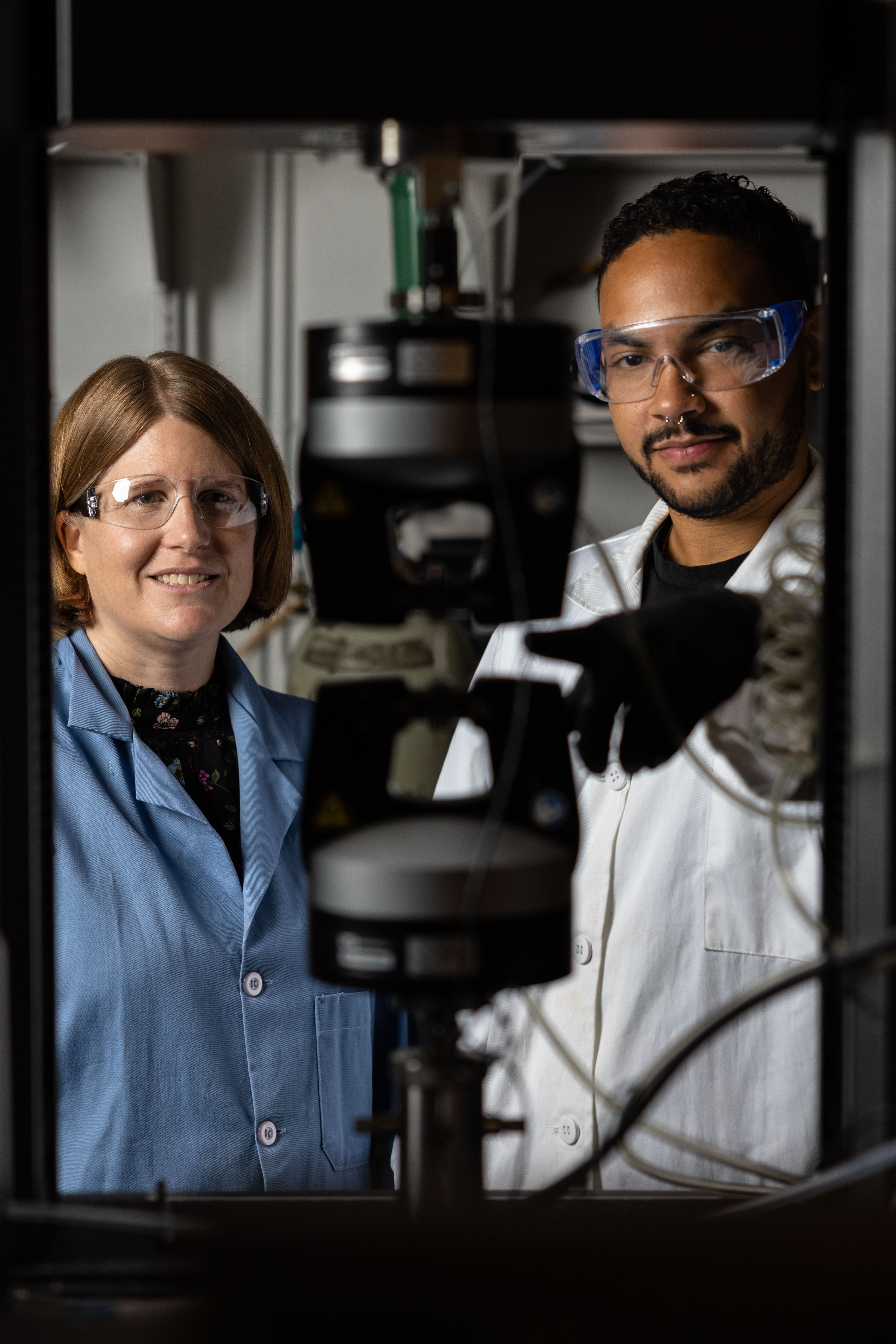 Megan Robertson working with a graduate student in her lab