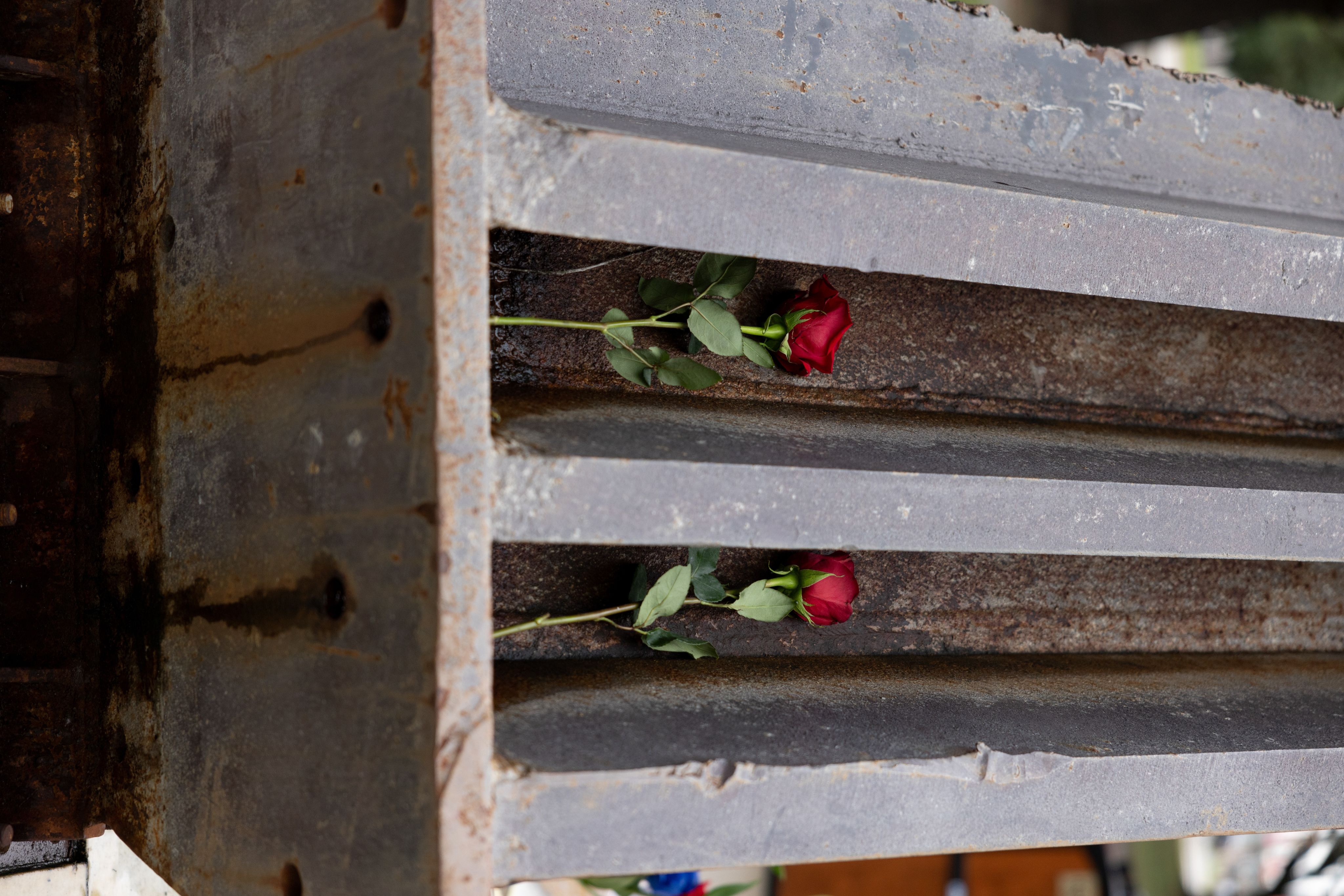 Two red roses laid on the World Trade Center Memorial at UH