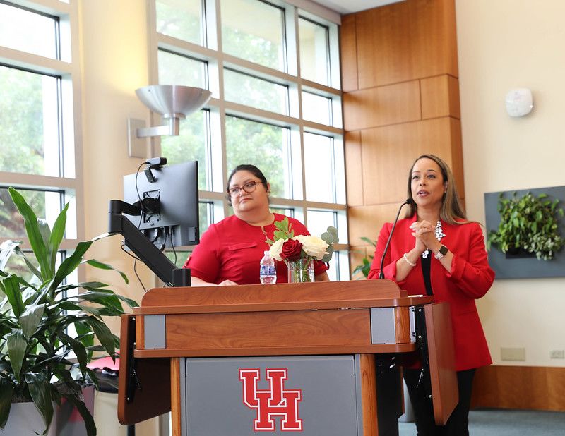 Two members of Staff Council leadership standing behind a podium, about to announce the winners of the Staff Council awards.