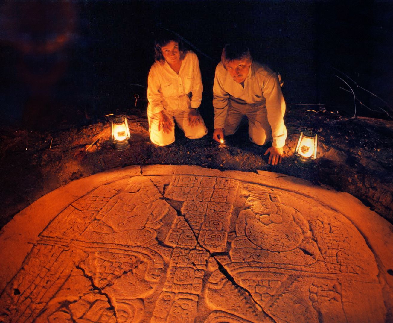 a woman and man sitting in a tomb