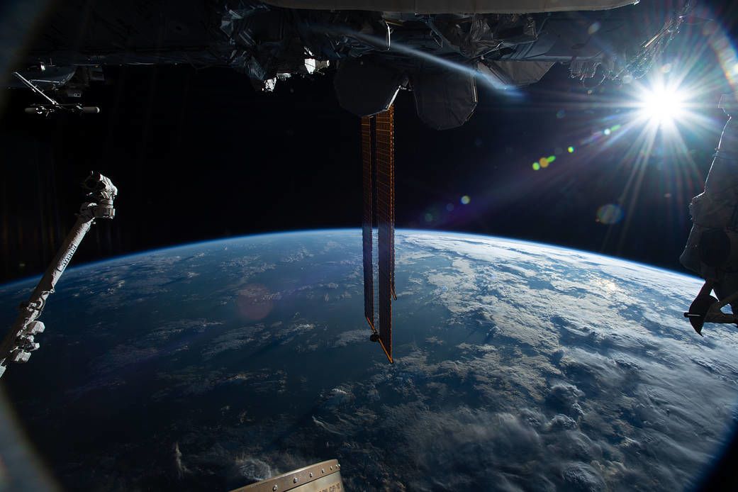 photo of Earth with sun in backdrop from International Space Station