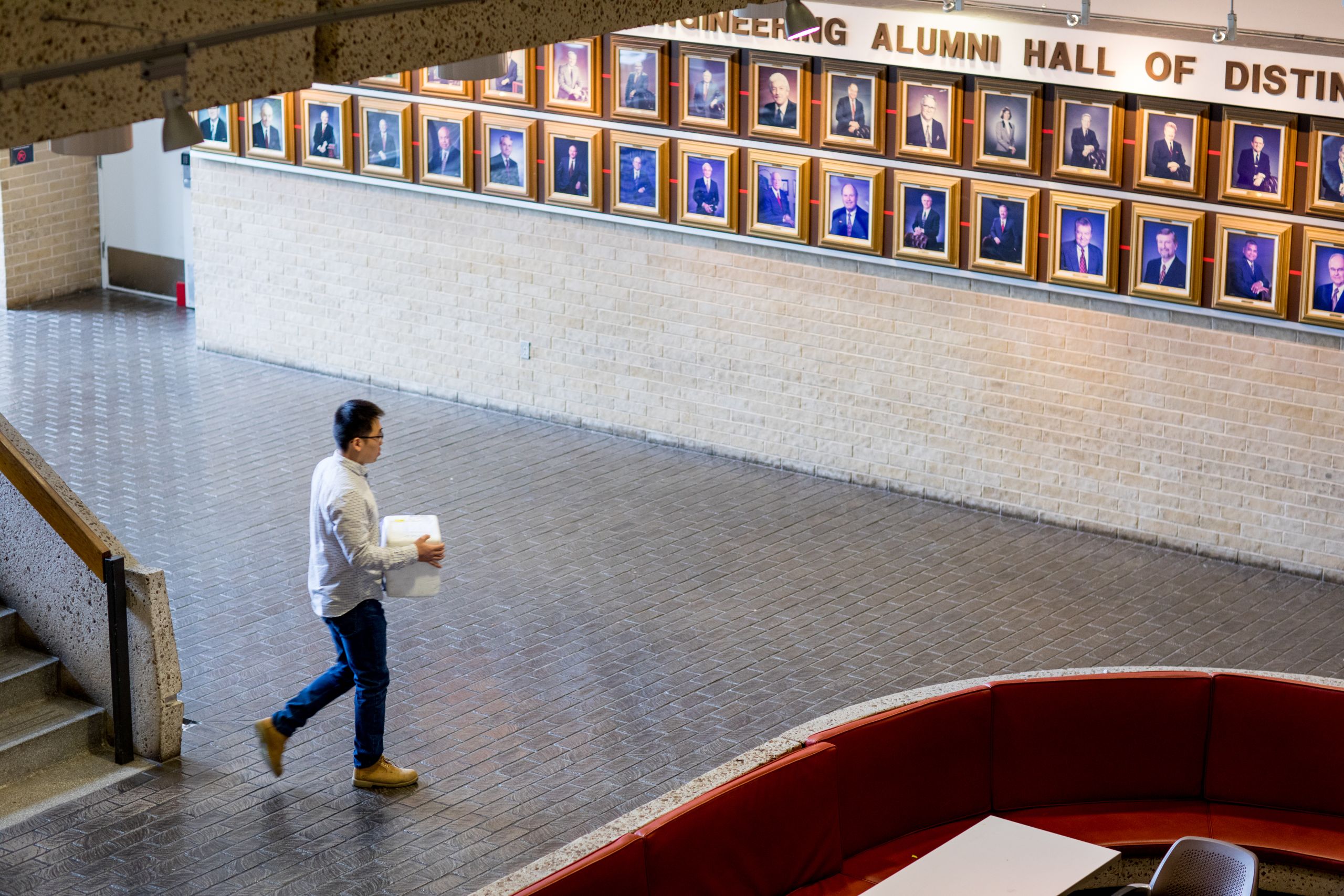 Yuechuan Xu walking with styrofoam cooler