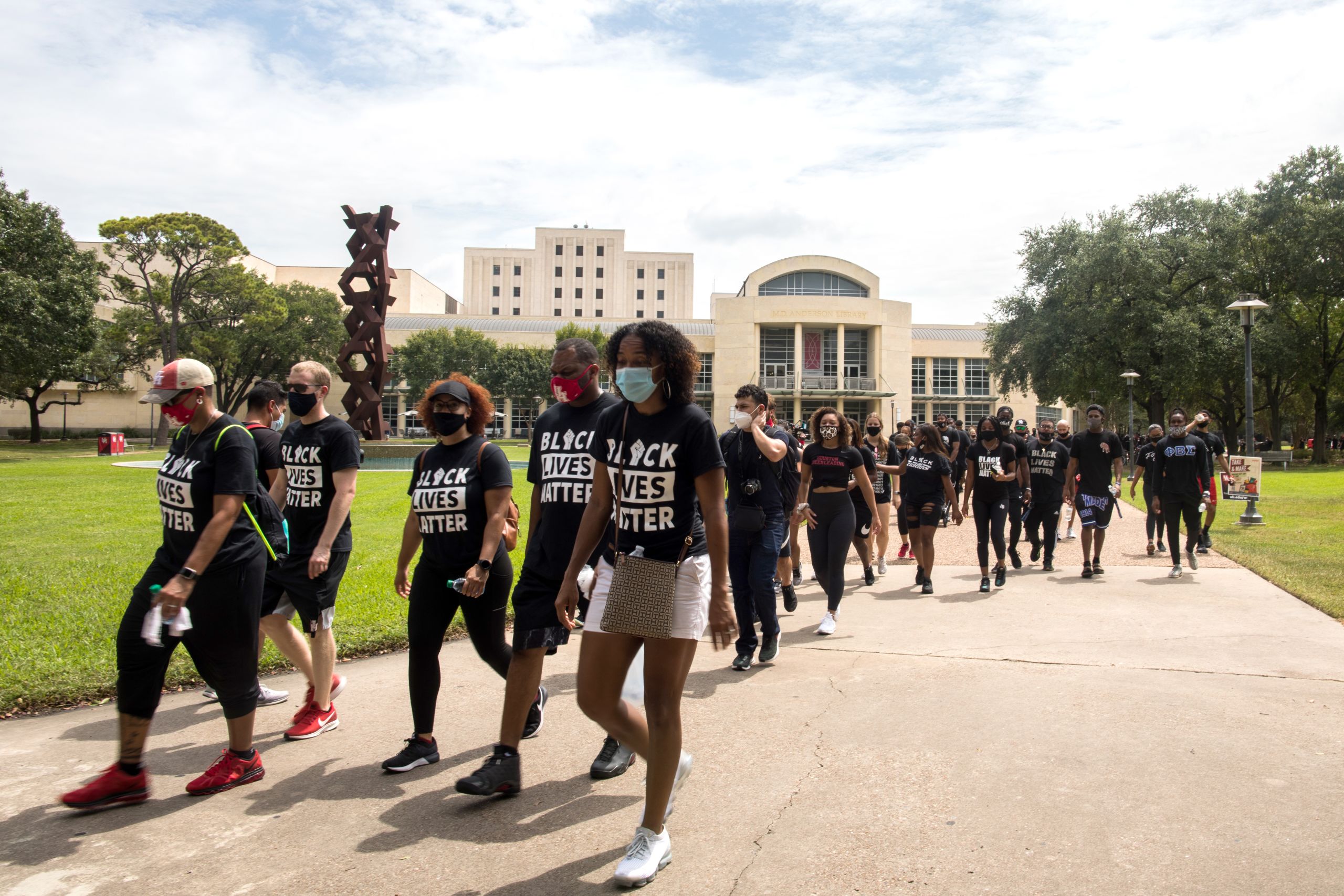 People marching and wearing Black Lives Matter t-shirt.