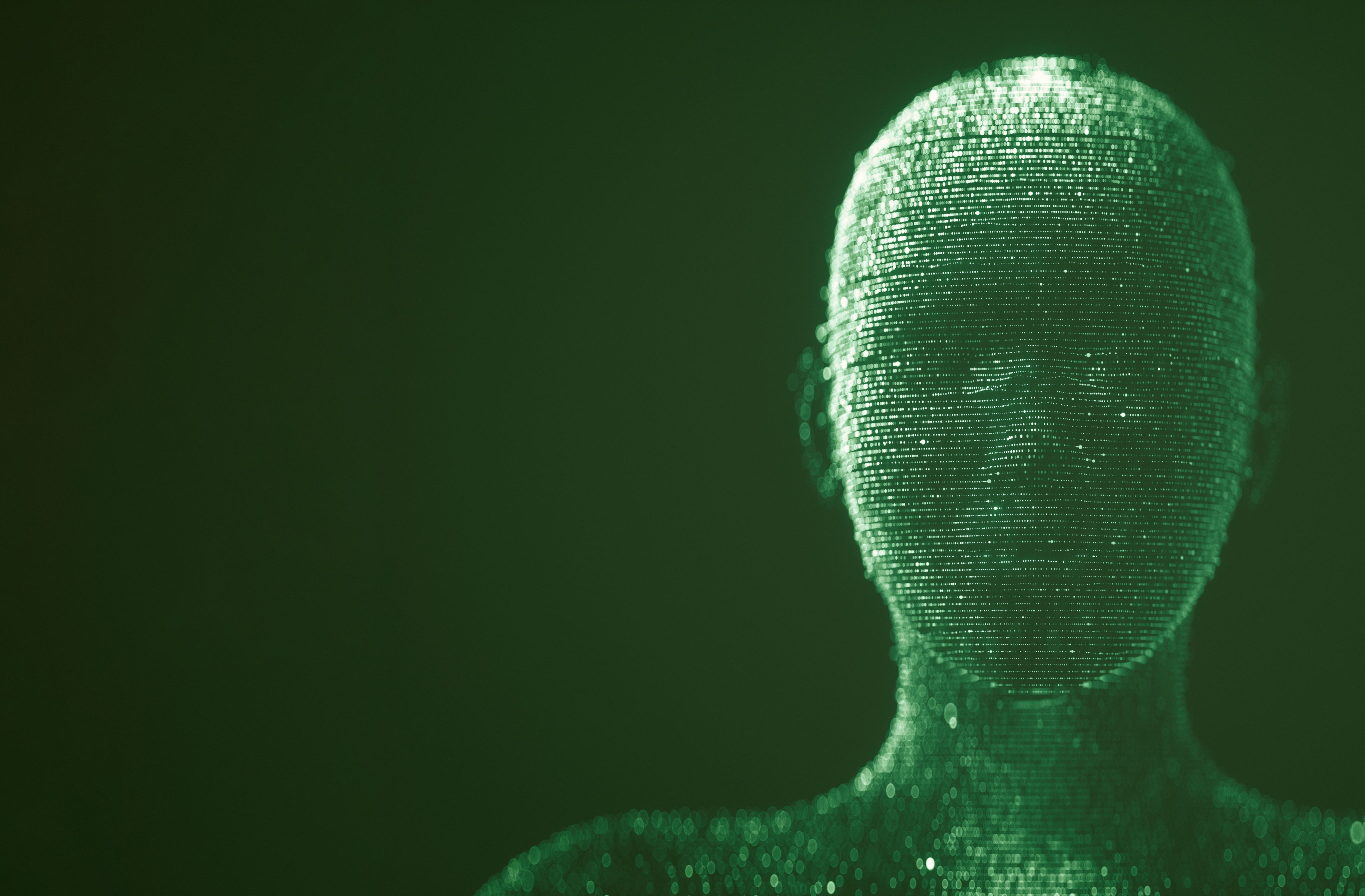 A green computer programed human face, in front of a dark green background.