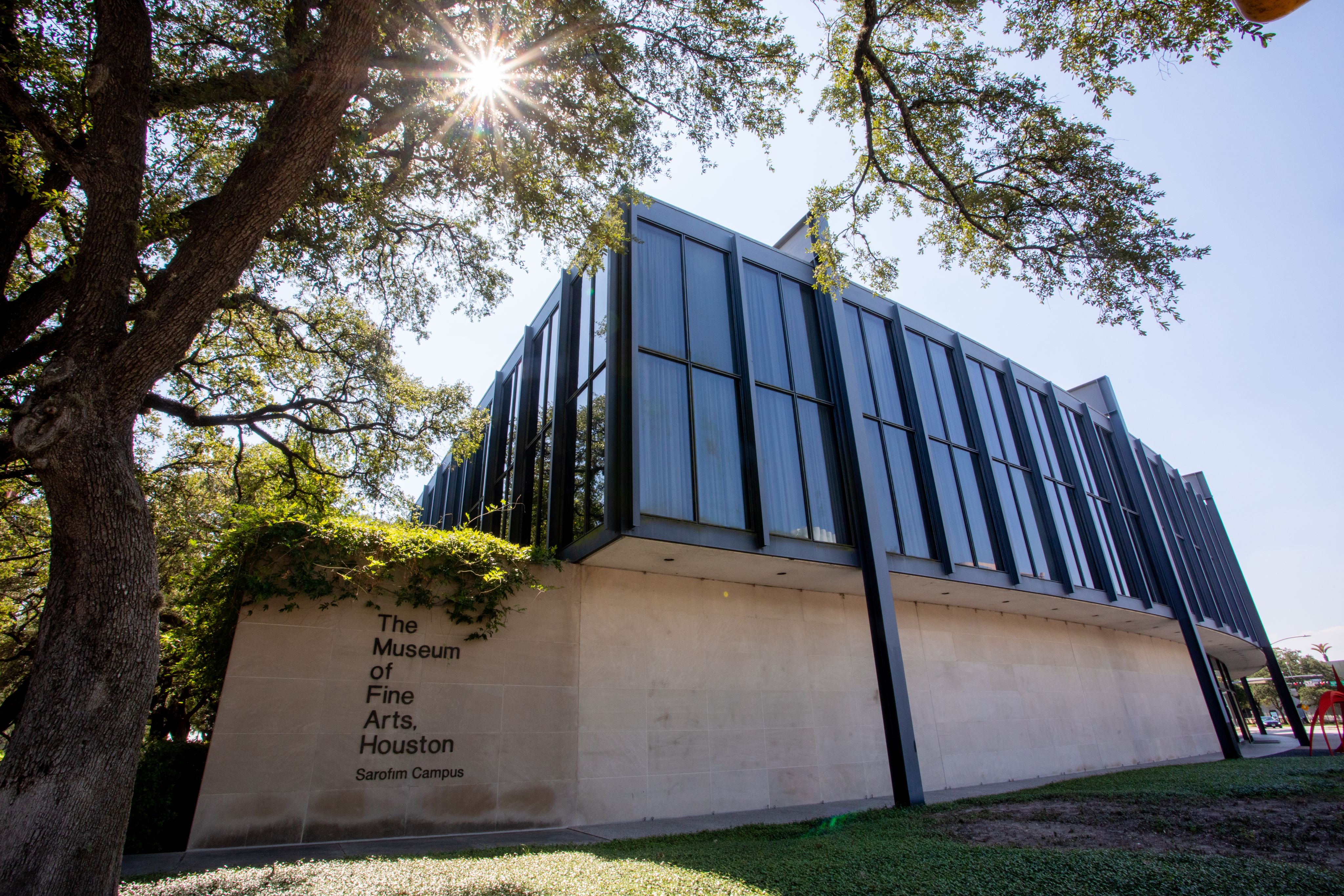 Exterior view of The Museum of Fine Arts, Houston featuring the museum name on the side of the building.