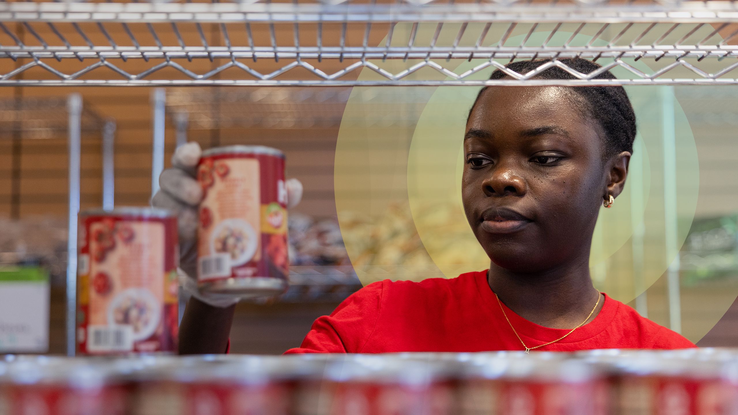 Close-up shot of a student worker stocking shelves at the Cougar Cupboard