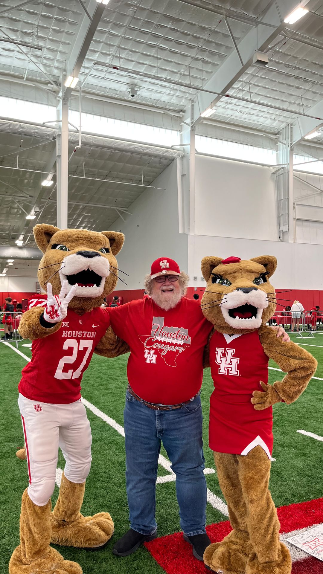 Donald Scherer poses with two University of Houston mascots