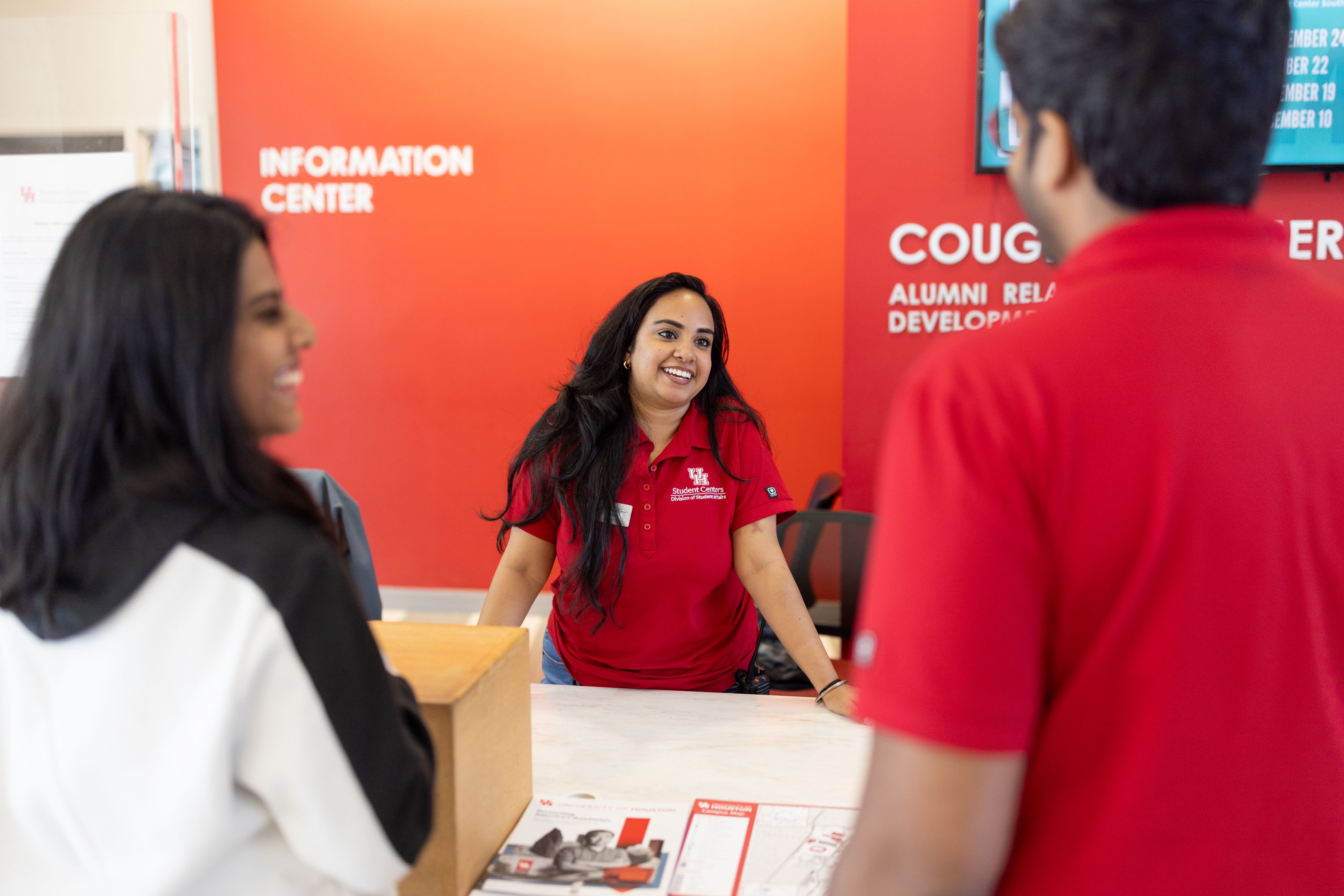Disha Vats, a customer relations manager at the information desk of the Student Center South, greets visitors