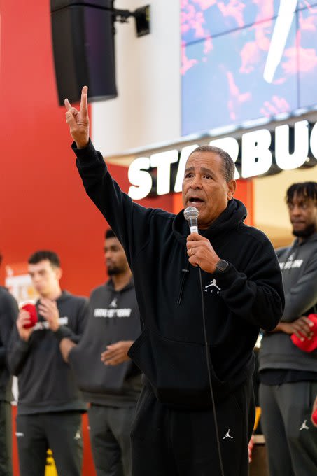 Men’s Basketball Head Coach Kelvin Sampson talking into a microphone.