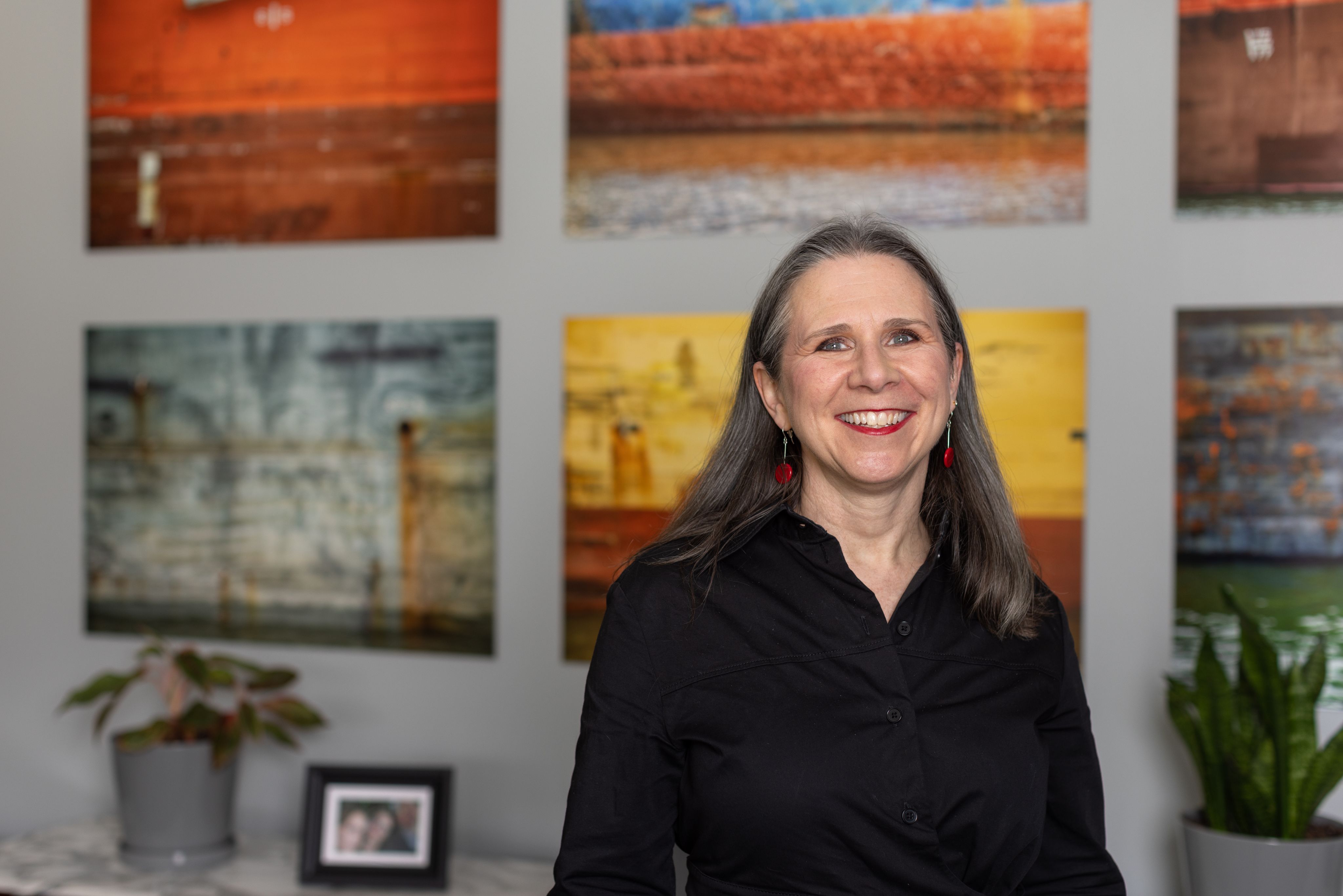 Catherine Horn, dean of the UH College of Education standing in front of artwork.