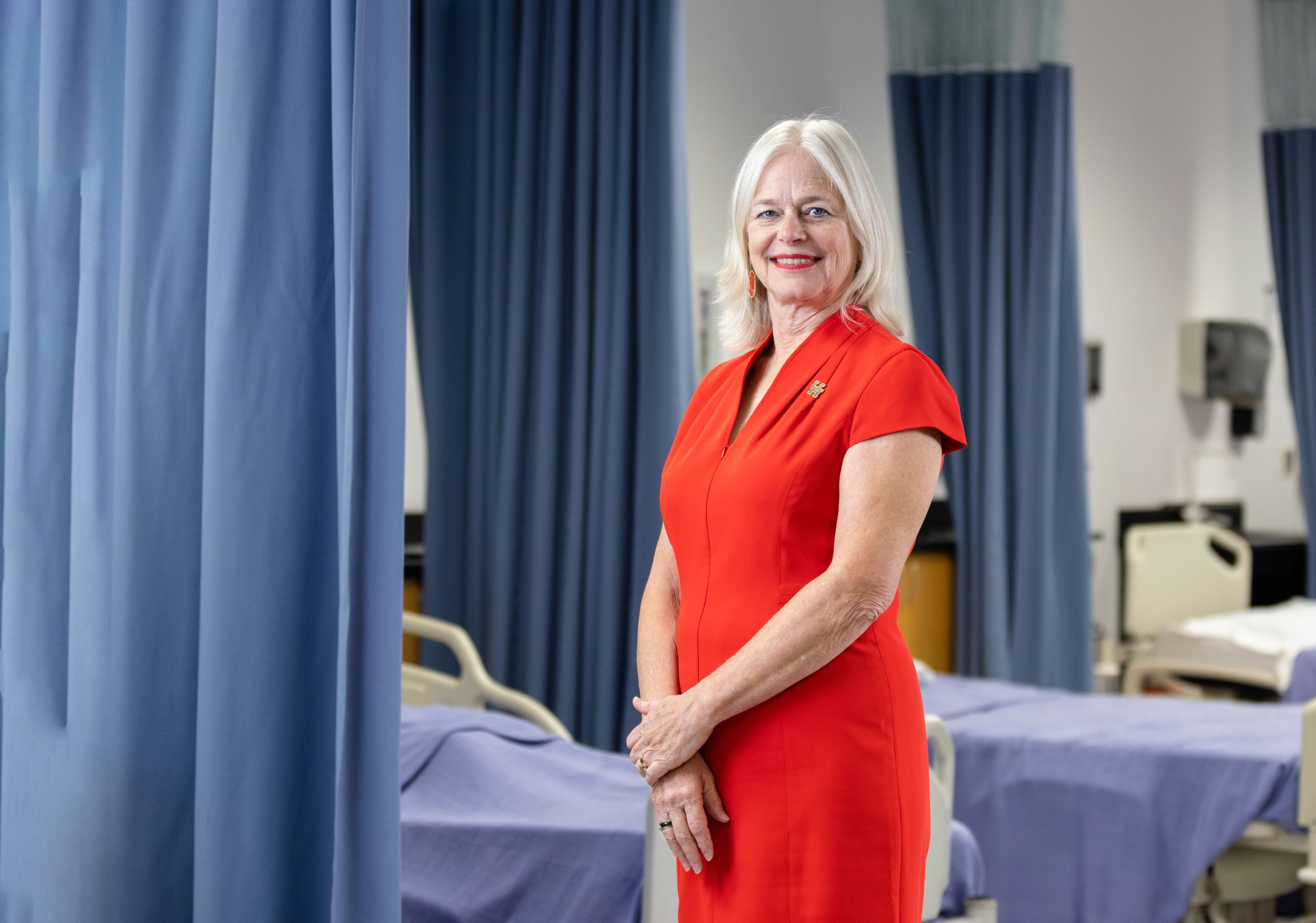 Kathryn Tart standing in front of empty hospital beds.