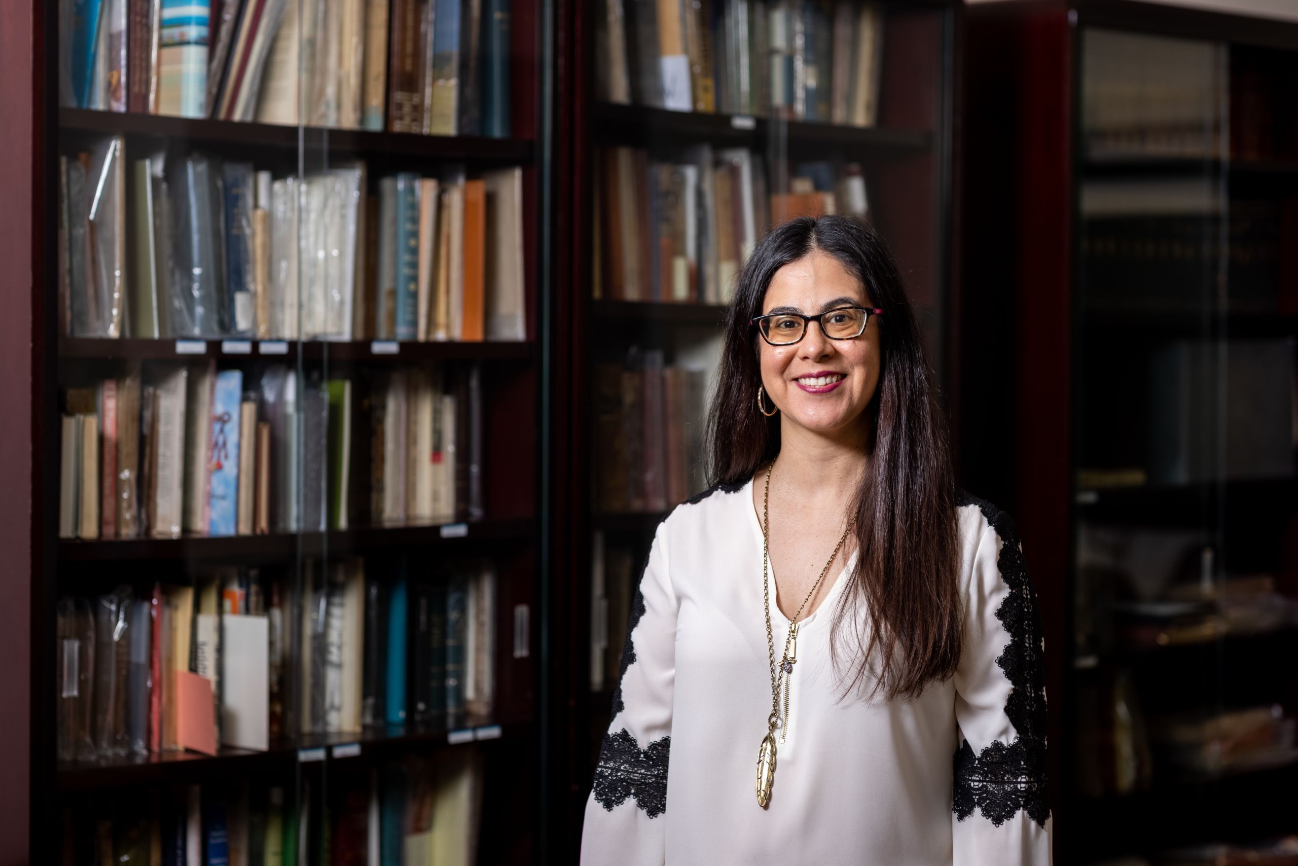 Portrait of Gauthereau in front of library book shelf