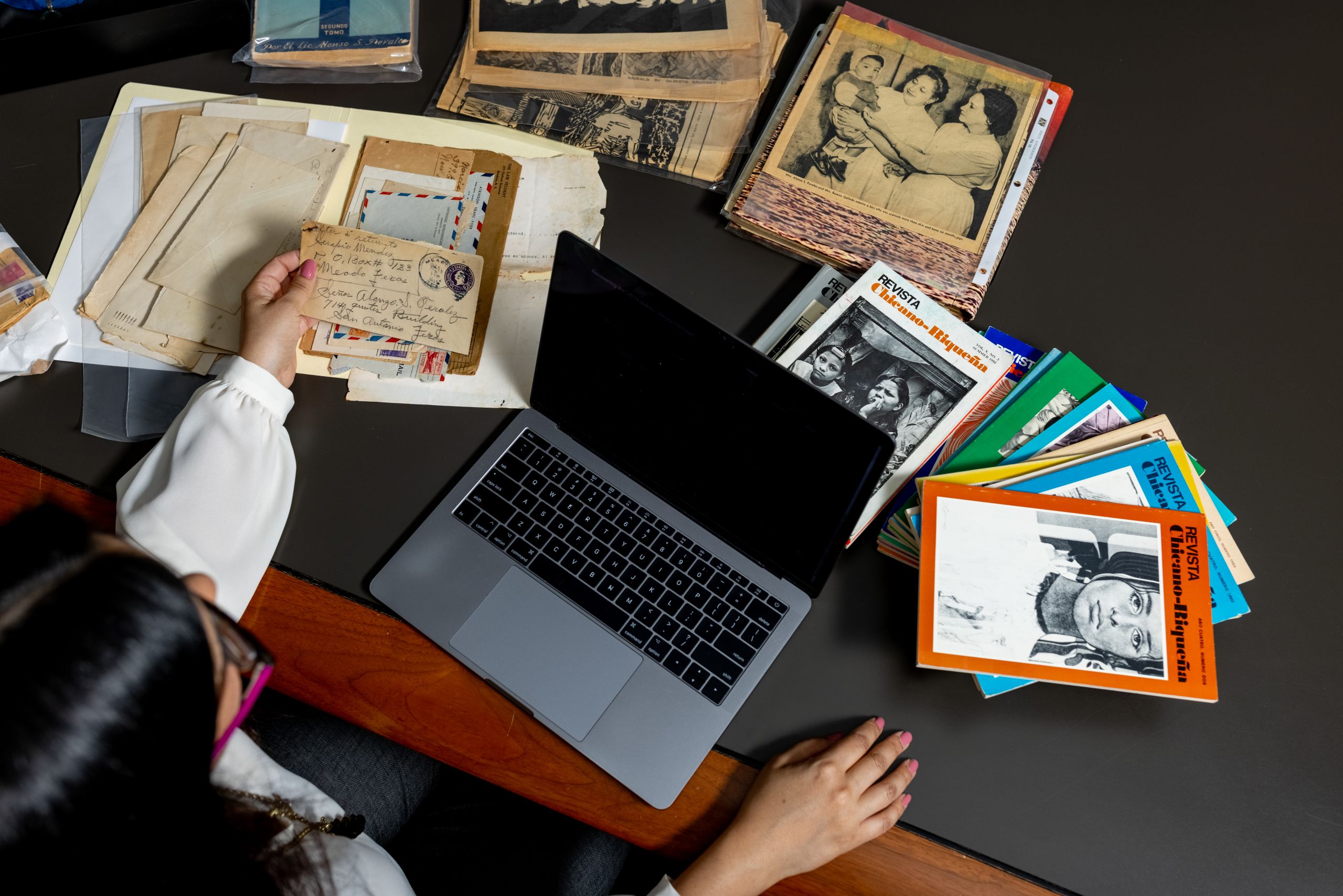 Gauthereau with literary archives spread across a desk.