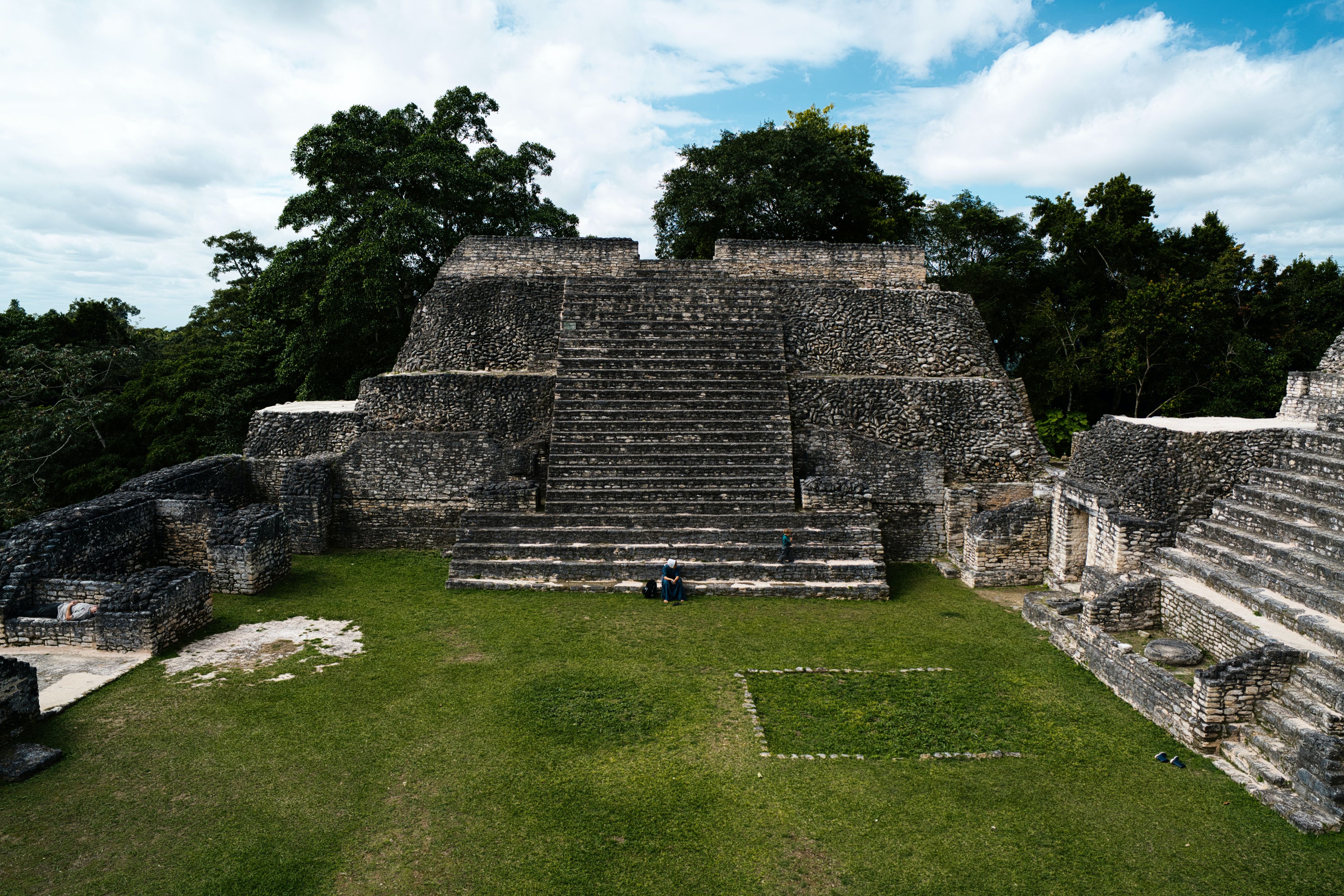 a large stone structure sitting on top of a lush green field