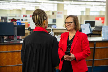 two women talking in a library