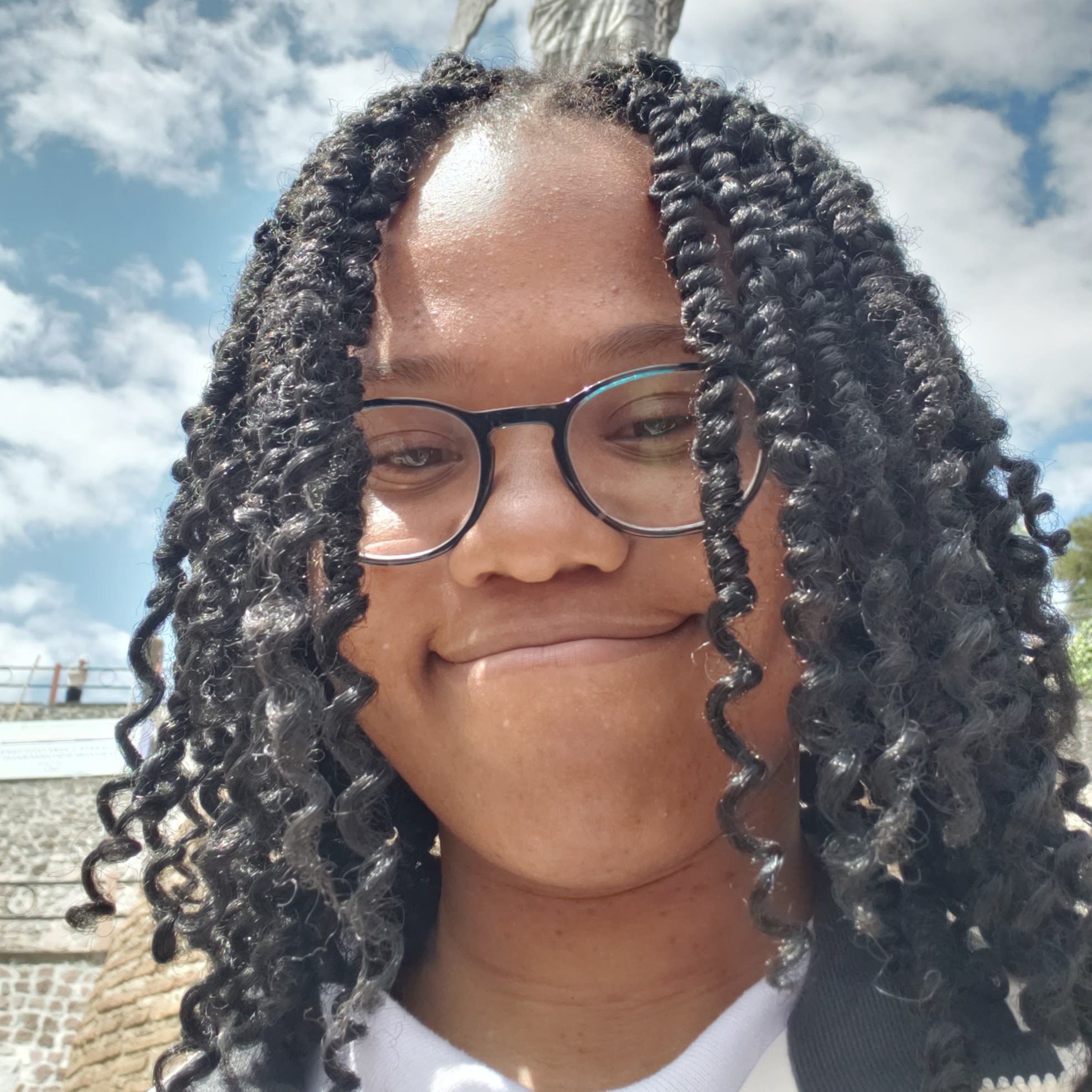 African American woman with long curly hair and glasses